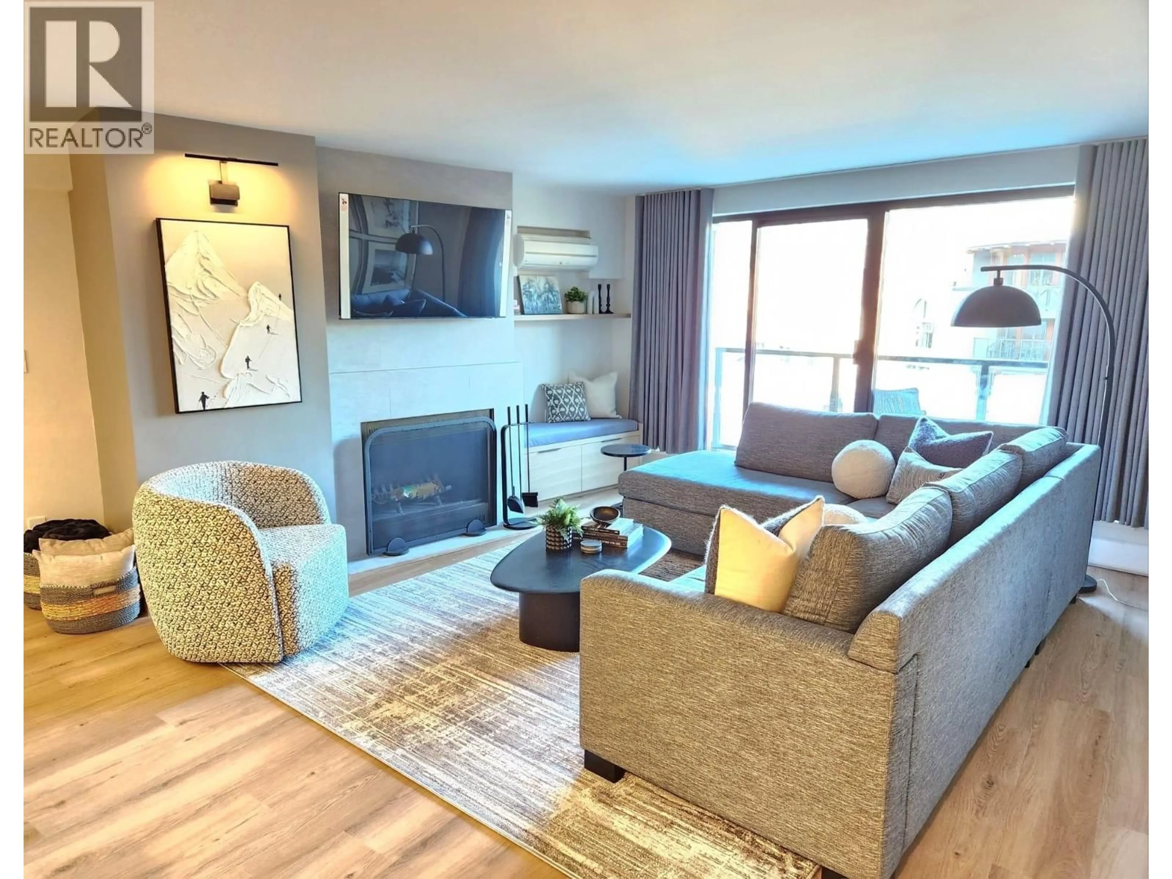 Living room with furniture, wood/laminate floor for 307 - 4280 MOUNTAIN SQUARE, Whistler British Columbia V8E1B9