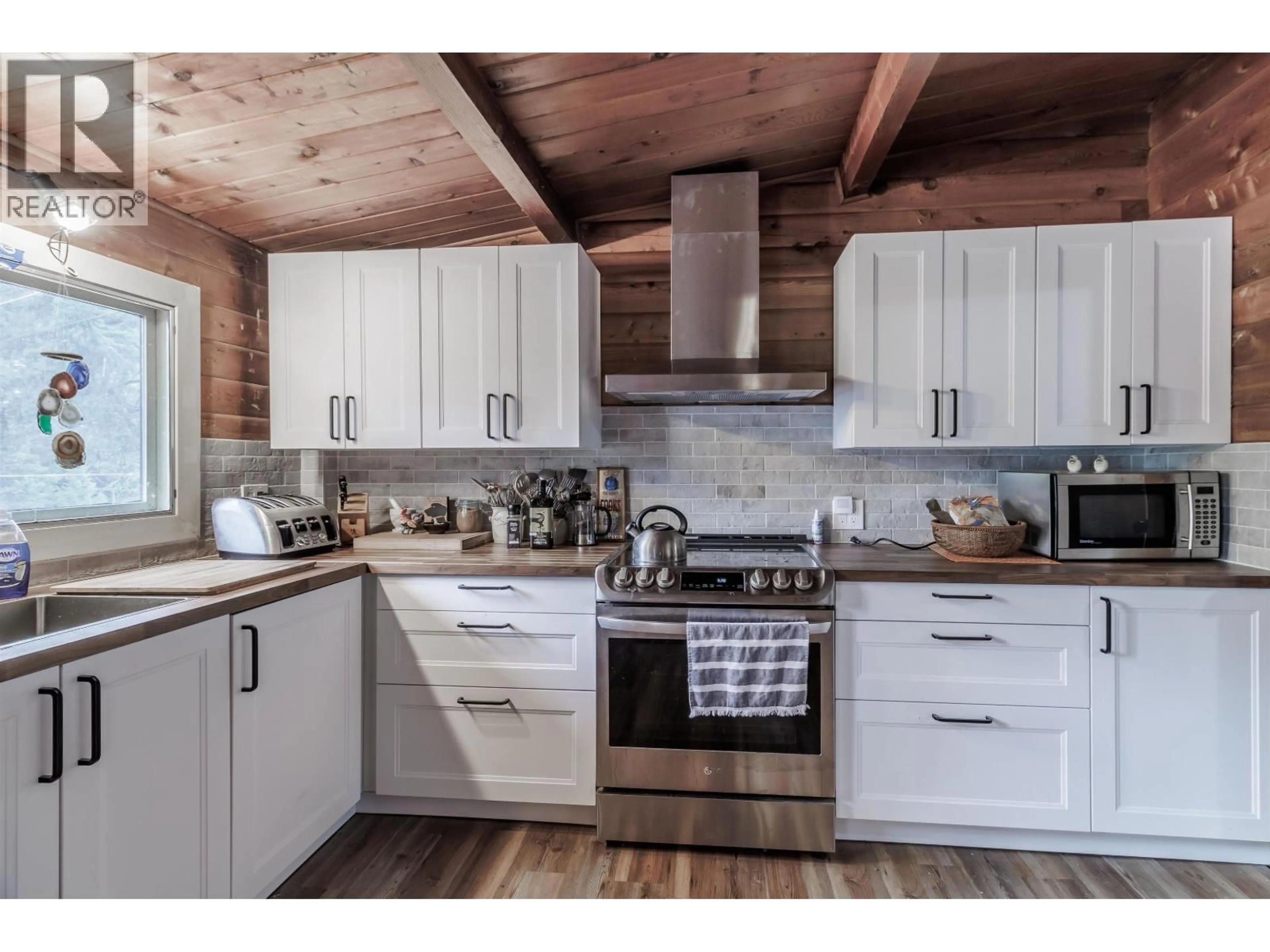 Open concept kitchen, wood/laminate floor for 6062 MAHOOD LAKE ROAD, Deka Lake / Sulphurous / Hathaway Lakes British Columbia V0K1X3