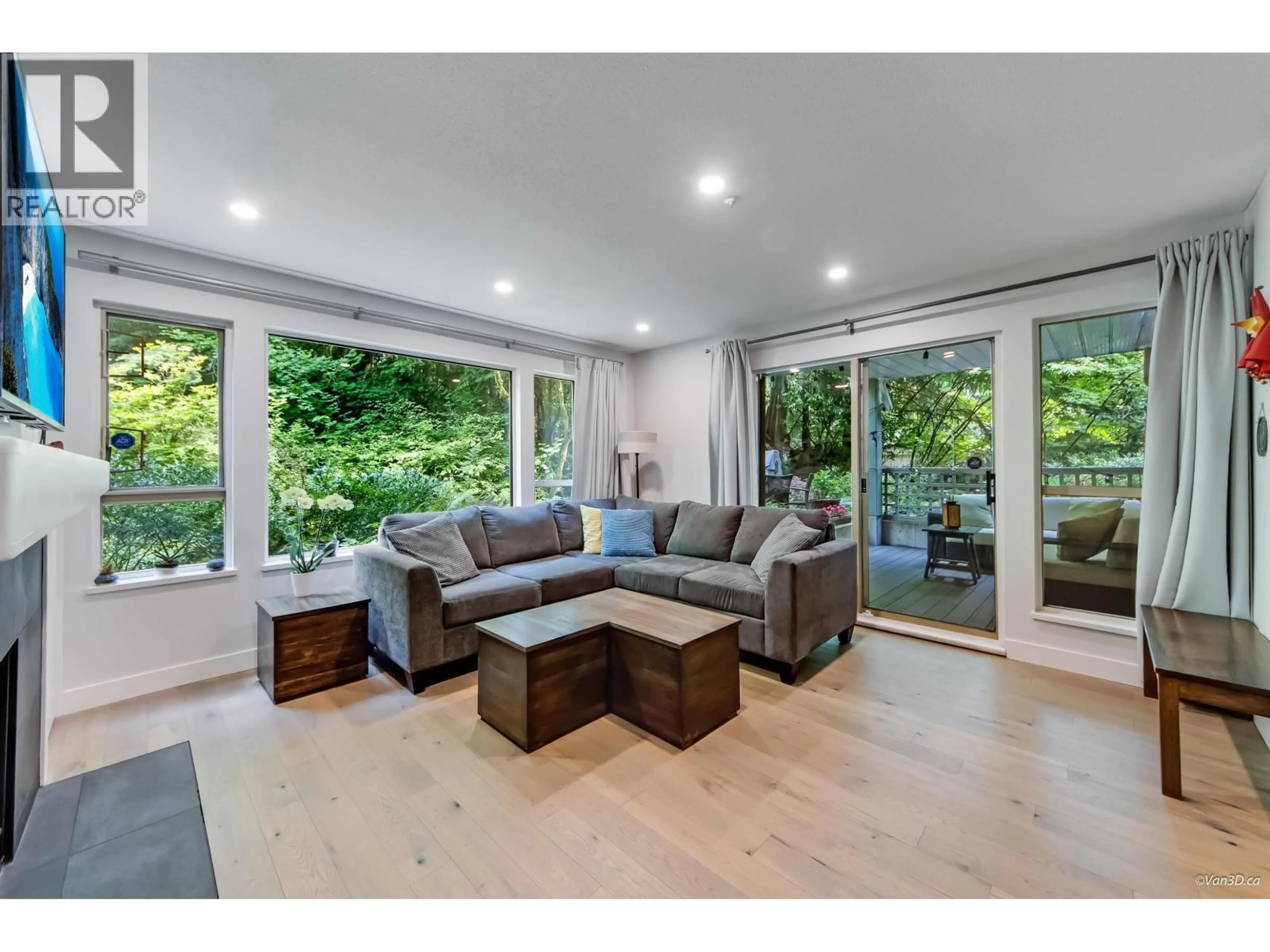 Living room with furniture, wood/laminate floor for 110 - 3658 BANFF COURT, North Vancouver British Columbia V7H2Z9