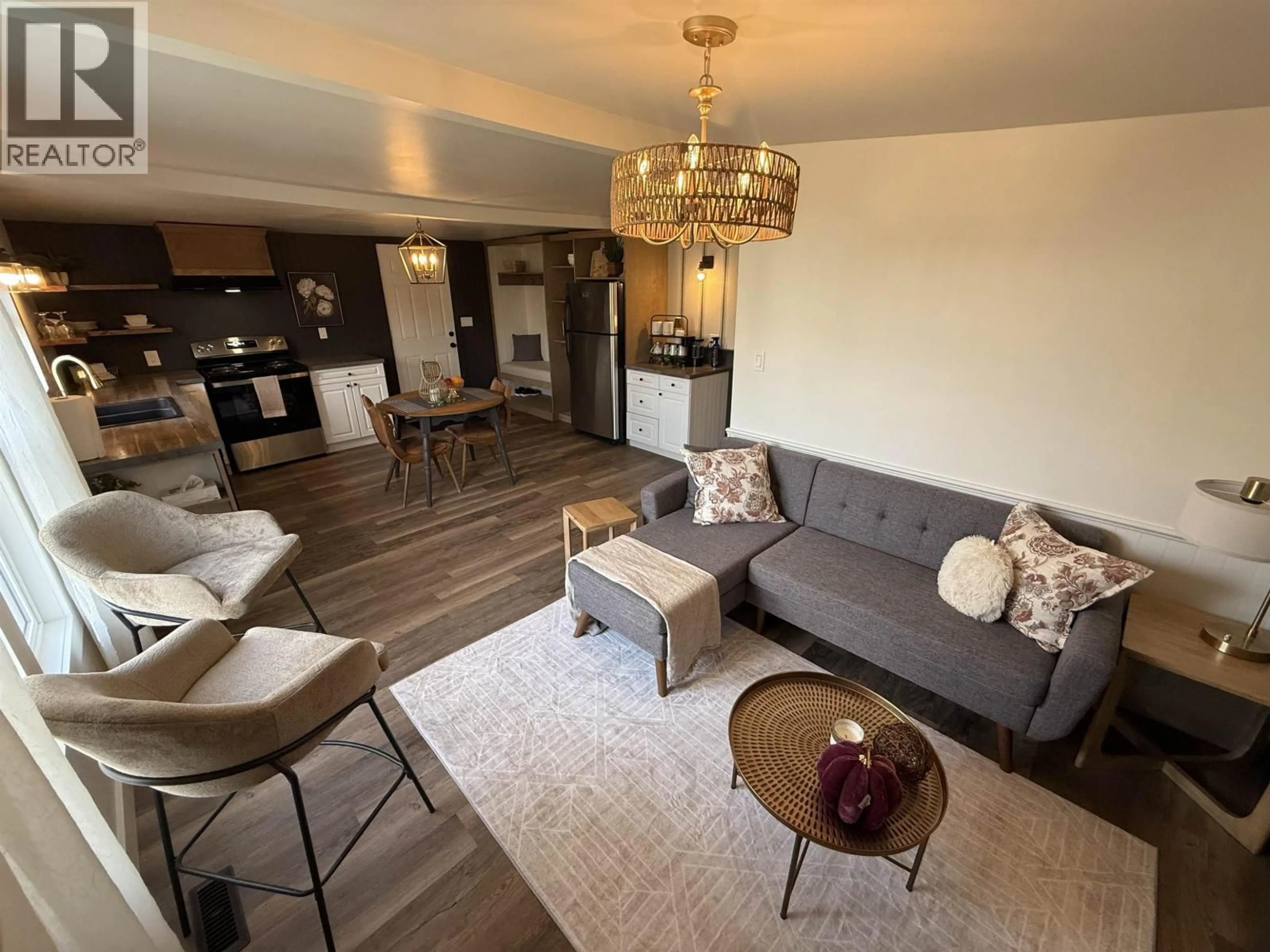 Living room with furniture, wood/laminate floor for 11019 102 AVENUE, Fort St. John British Columbia V1J2G2