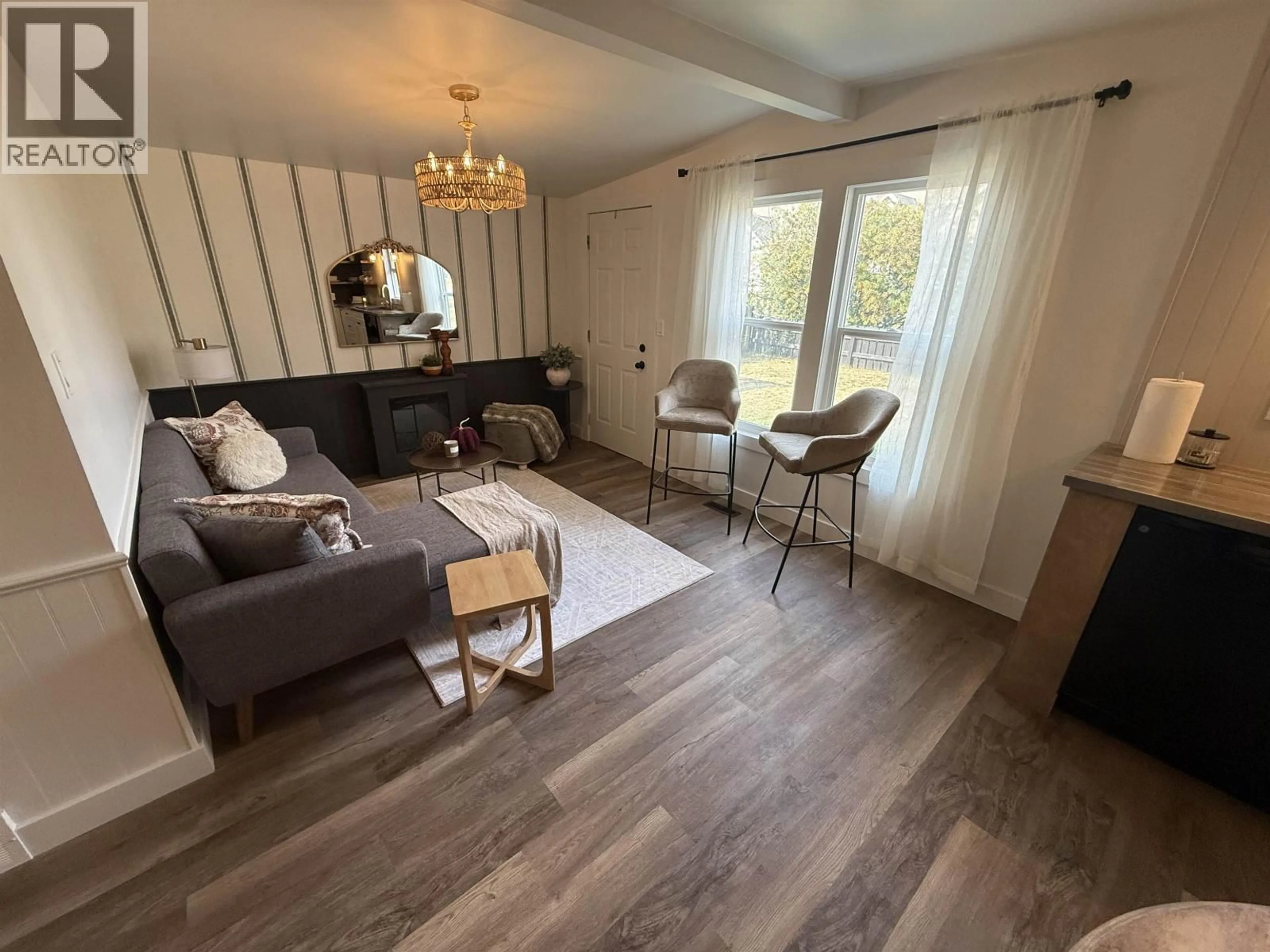 Living room with furniture, wood/laminate floor for 11019 102 AVENUE, Fort St. John British Columbia V1J2G2