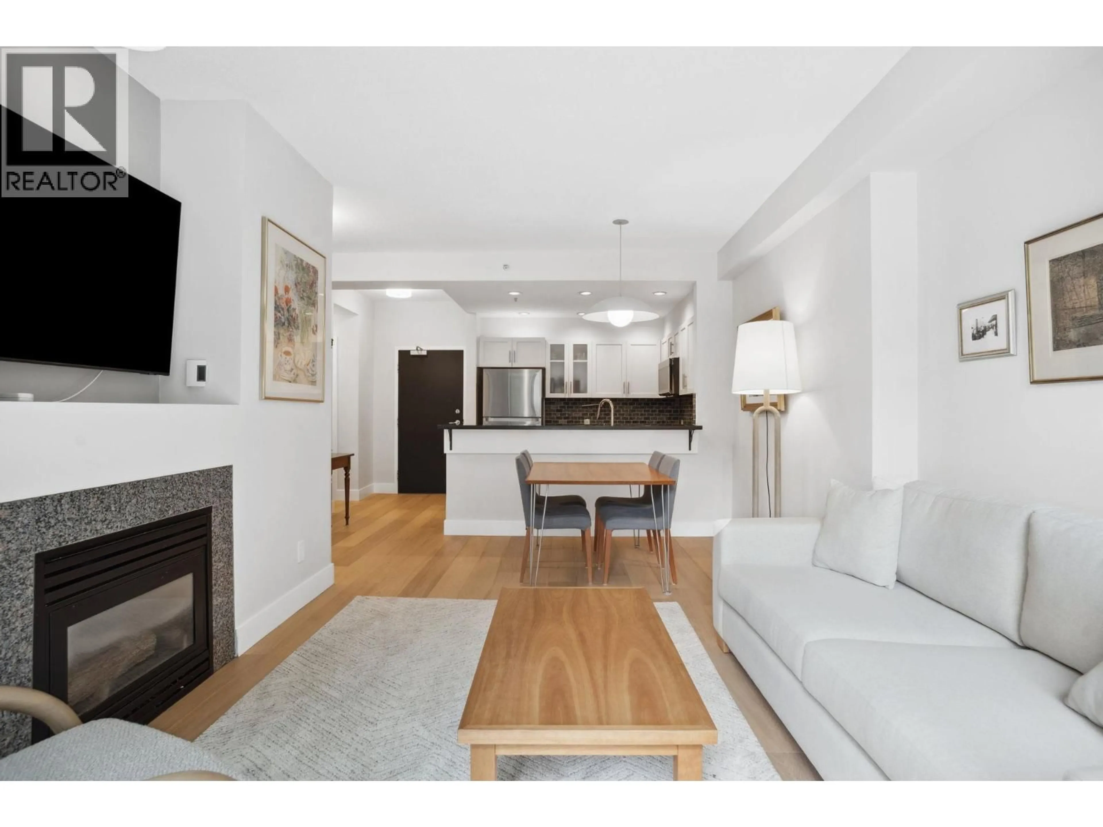 Living room with furniture, wood/laminate floor for 100 - 1688 ROBSON STREET, Vancouver British Columbia V6G1C7