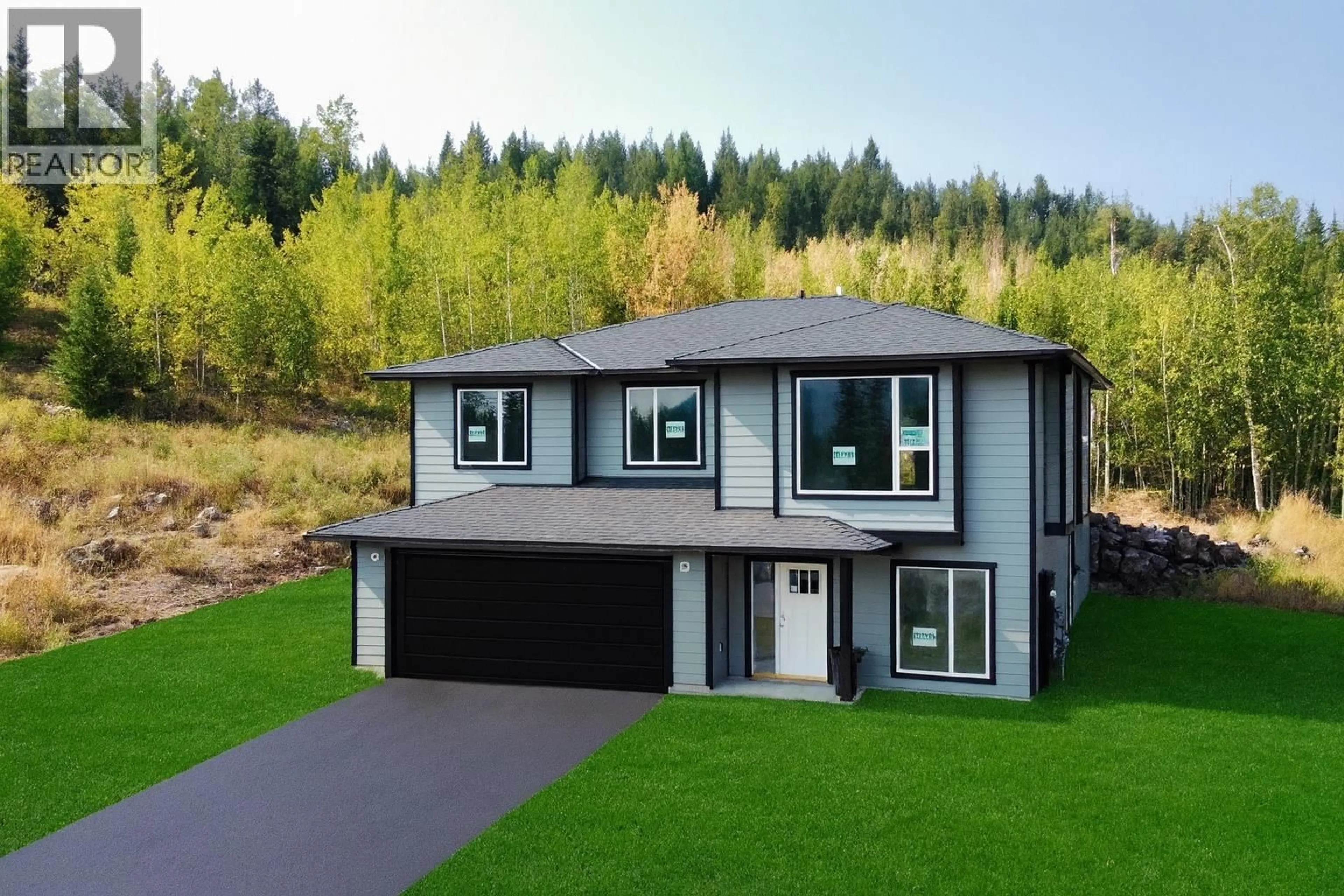 A pic from outside/outdoor area/front of a property/back of a property/a pic from drone, unknown for 905 SPRUCE PLACE, 100 Mile House British Columbia V0K2E0
