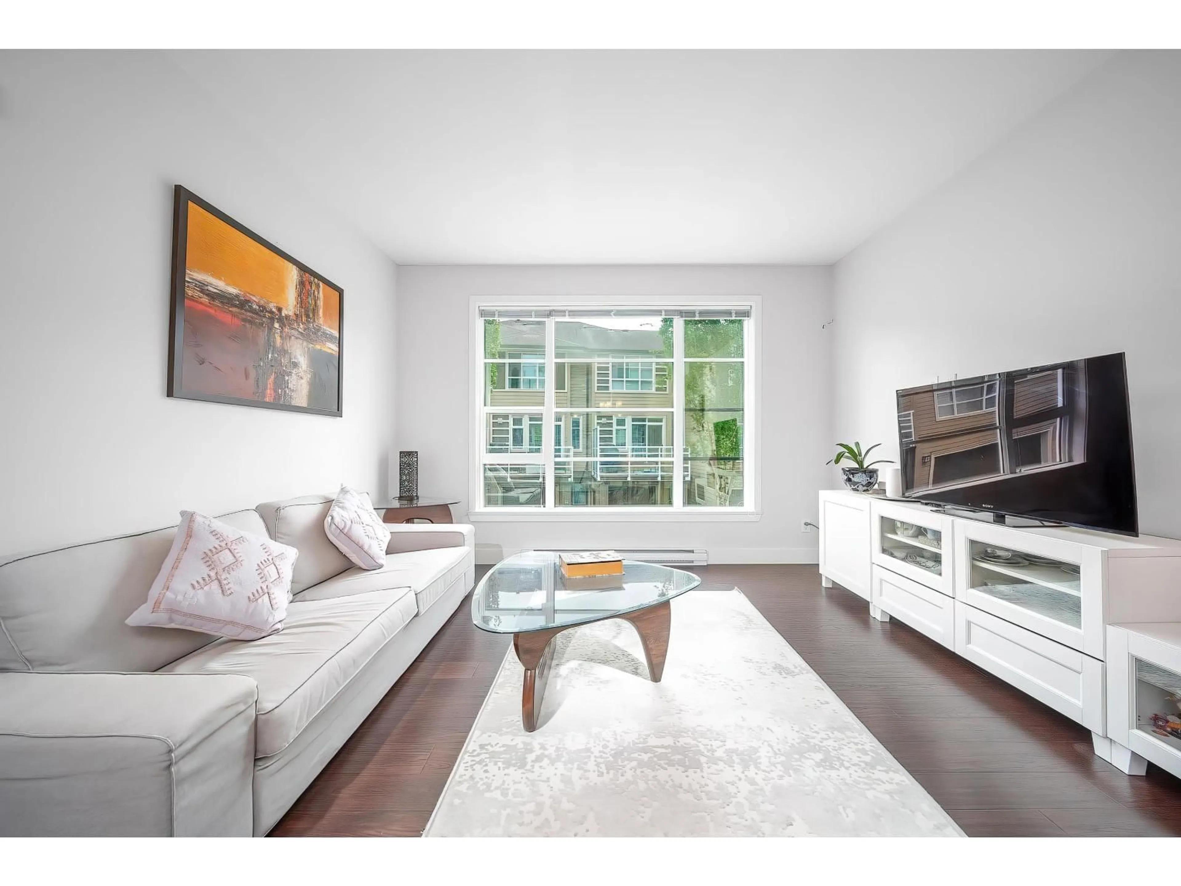 Living room with furniture, wood/laminate floor for 49 - 15405 31, Surrey British Columbia V3Z2W5
