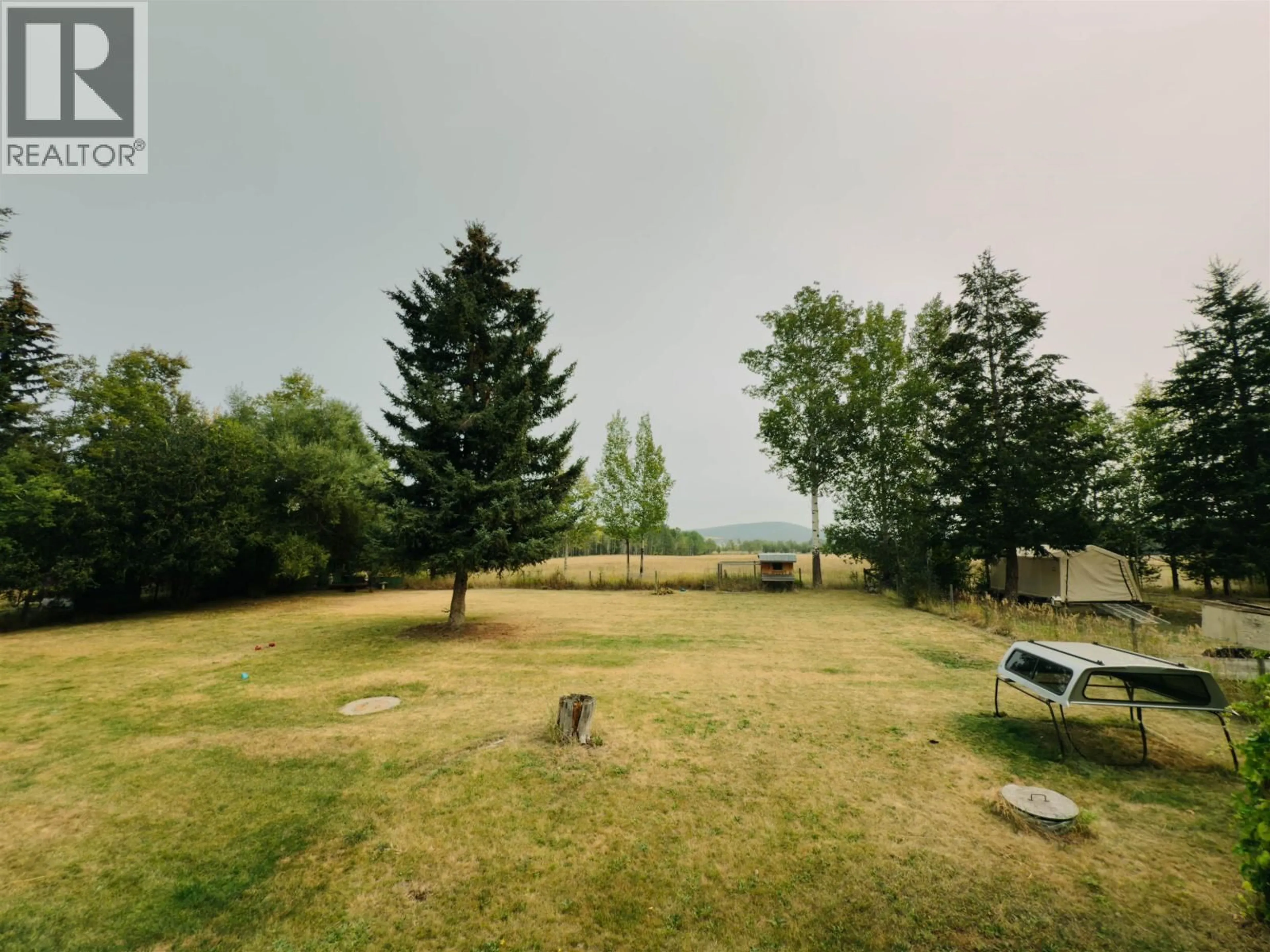 A pic from outside/outdoor area/front of a property/back of a property/a pic from drone, water/lake/river/ocean view for 6497 GREY CRESCENT, Horse Lake British Columbia V0K2E3