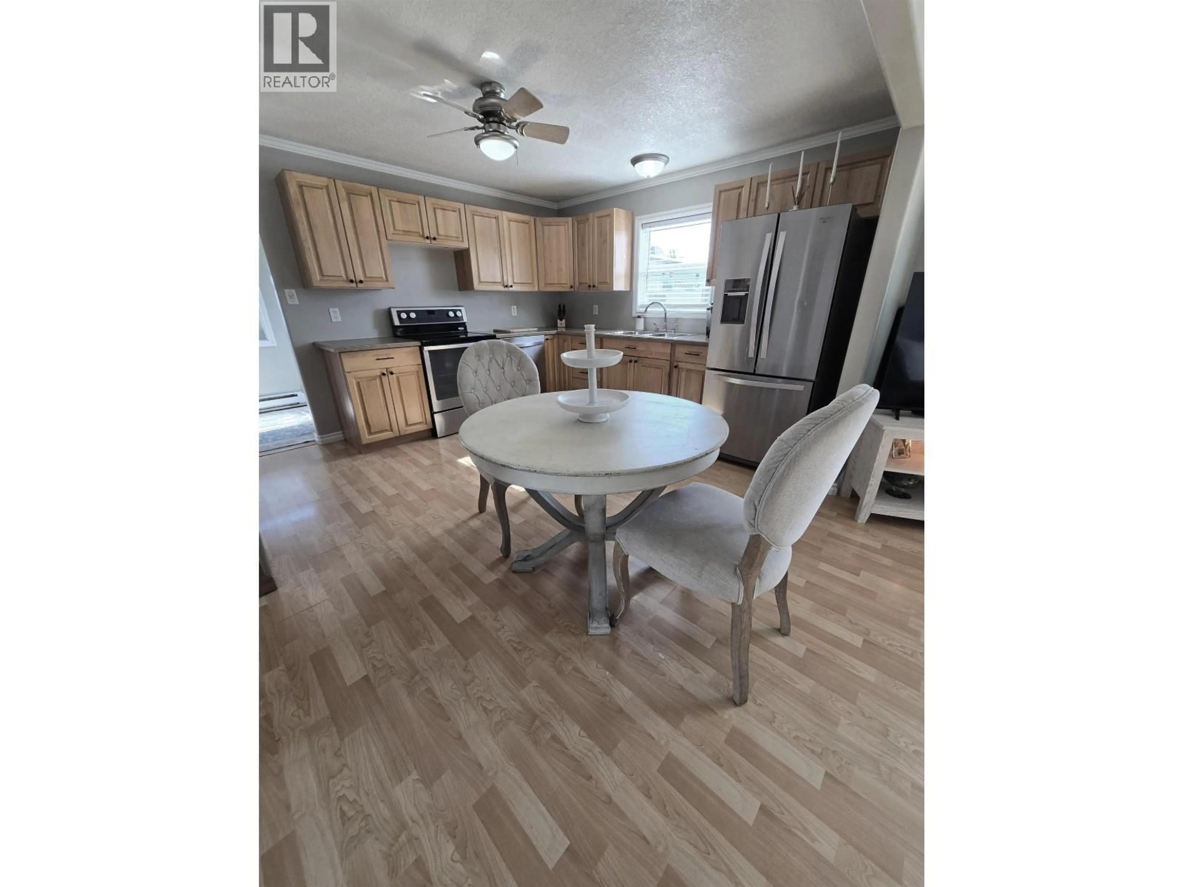 Open concept kitchen, wood/laminate floor for 8224 99 AVENUE, Fort St. John British Columbia V1J1S7