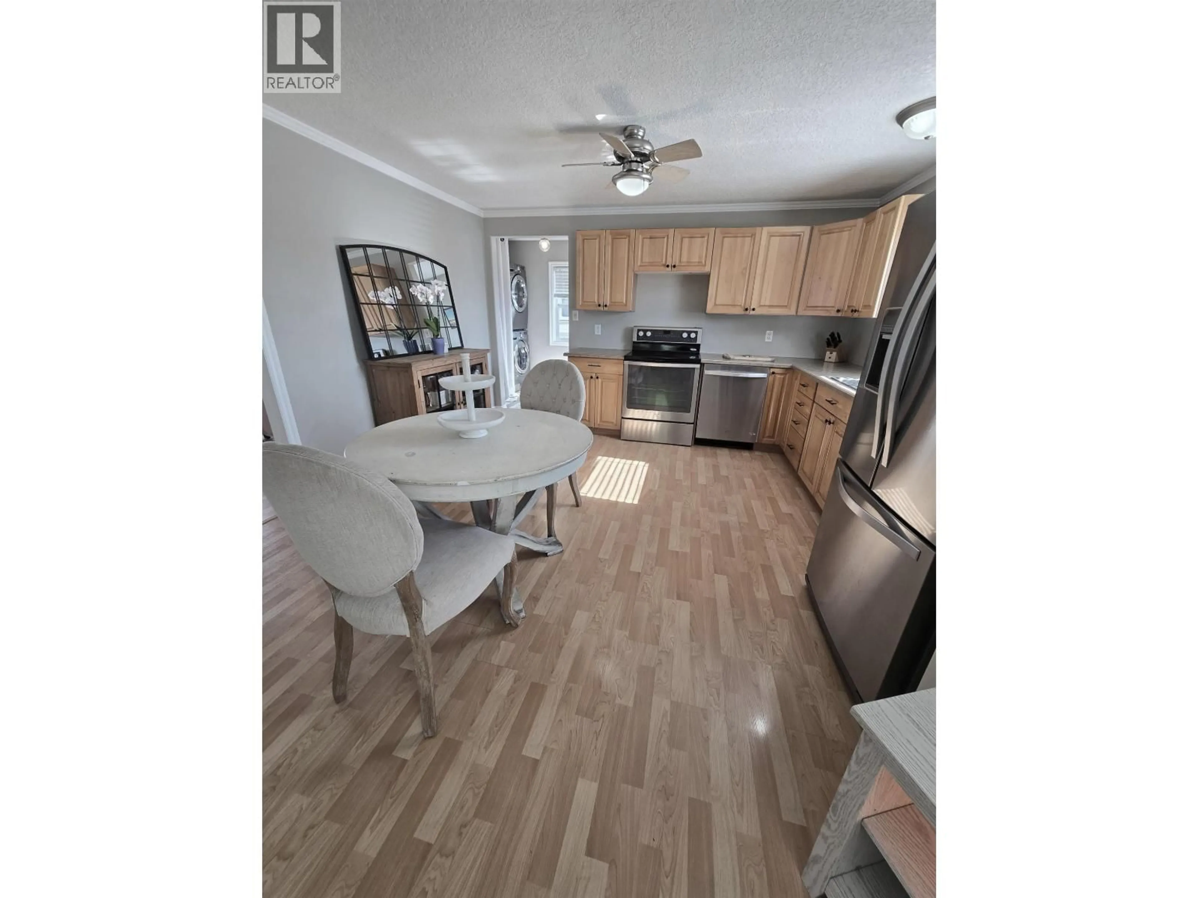 Open concept kitchen, wood/laminate floor for 8224 99 AVENUE, Fort St. John British Columbia V1J1S7