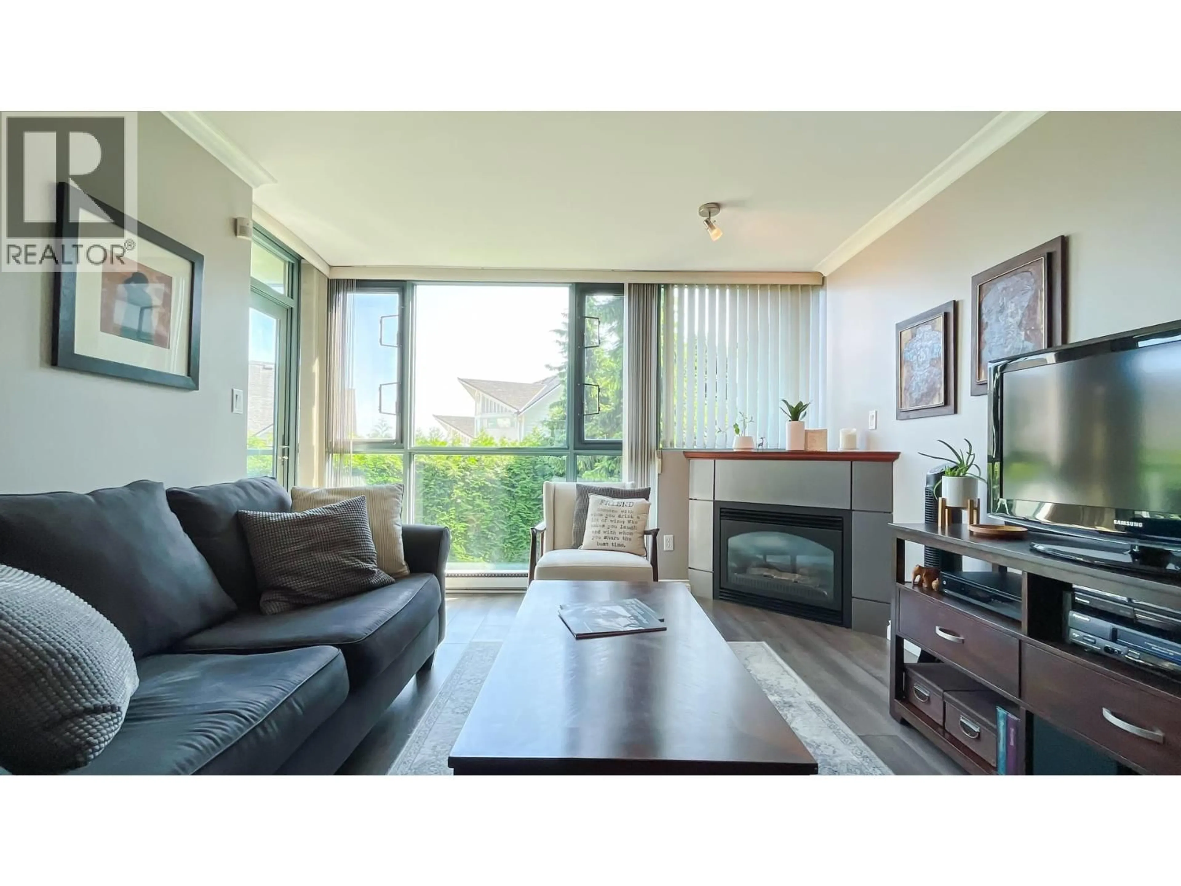 Living room with furniture, wood/laminate floor for 206 - 2733 CHANDLERY PLACE, Vancouver British Columbia V5S4V3