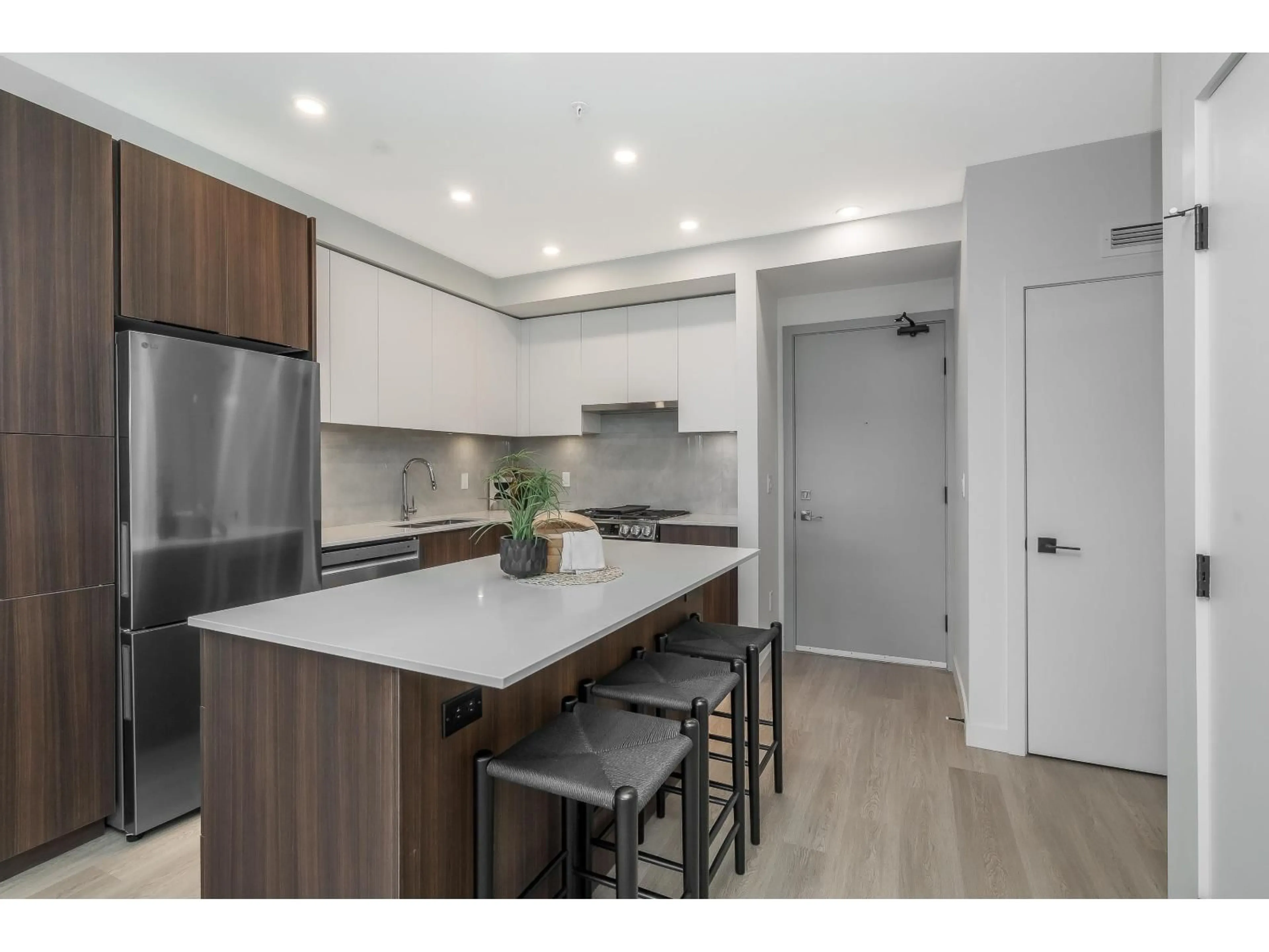 Open concept kitchen, wood/laminate floor for 403 - 7980 206A, Langley British Columbia V2Y3Z8