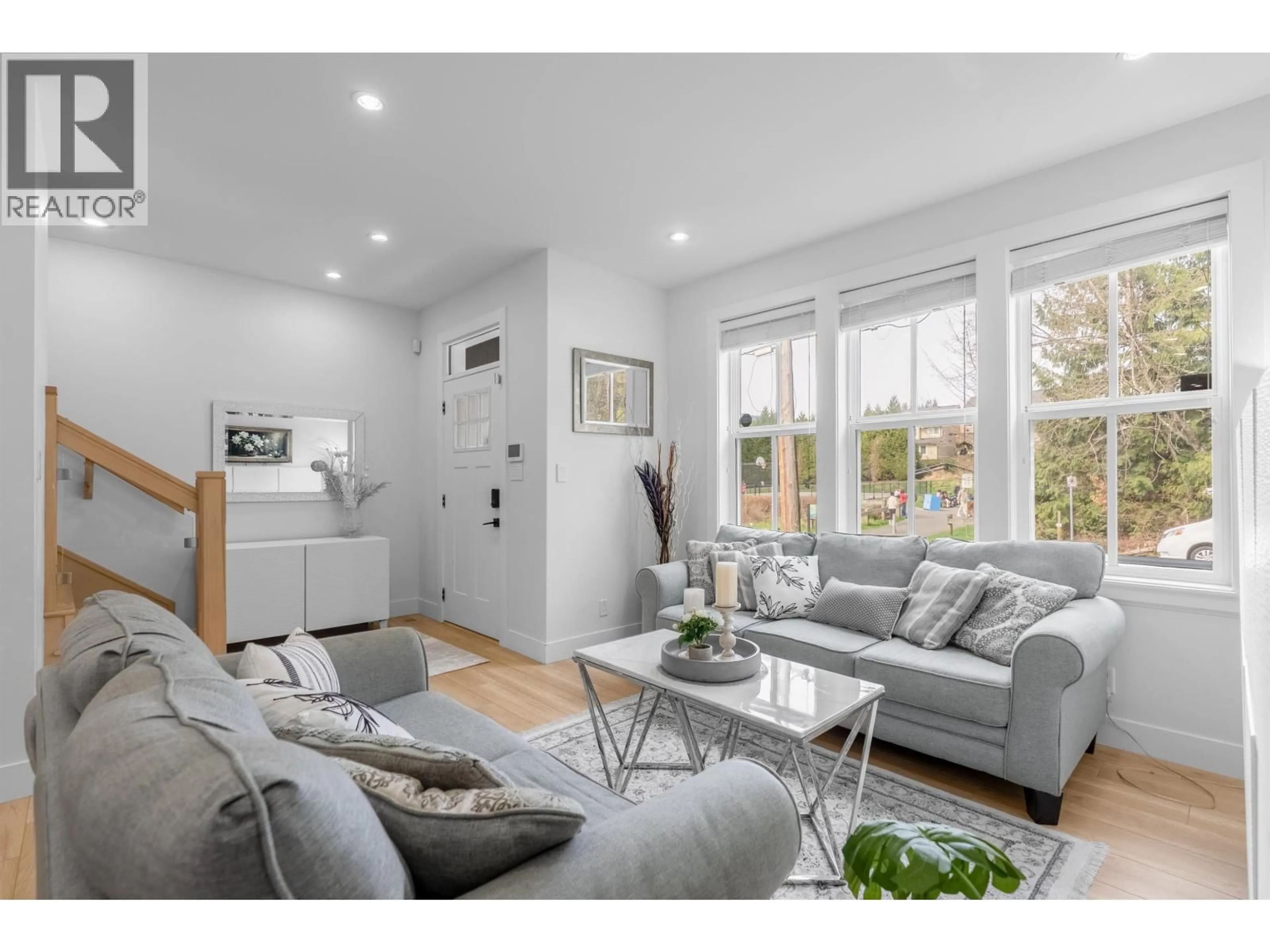 Living room with furniture, wood/laminate floor for 101 - 3416 QUEENSTON AVENUE, Coquitlam British Columbia V3E3H1
