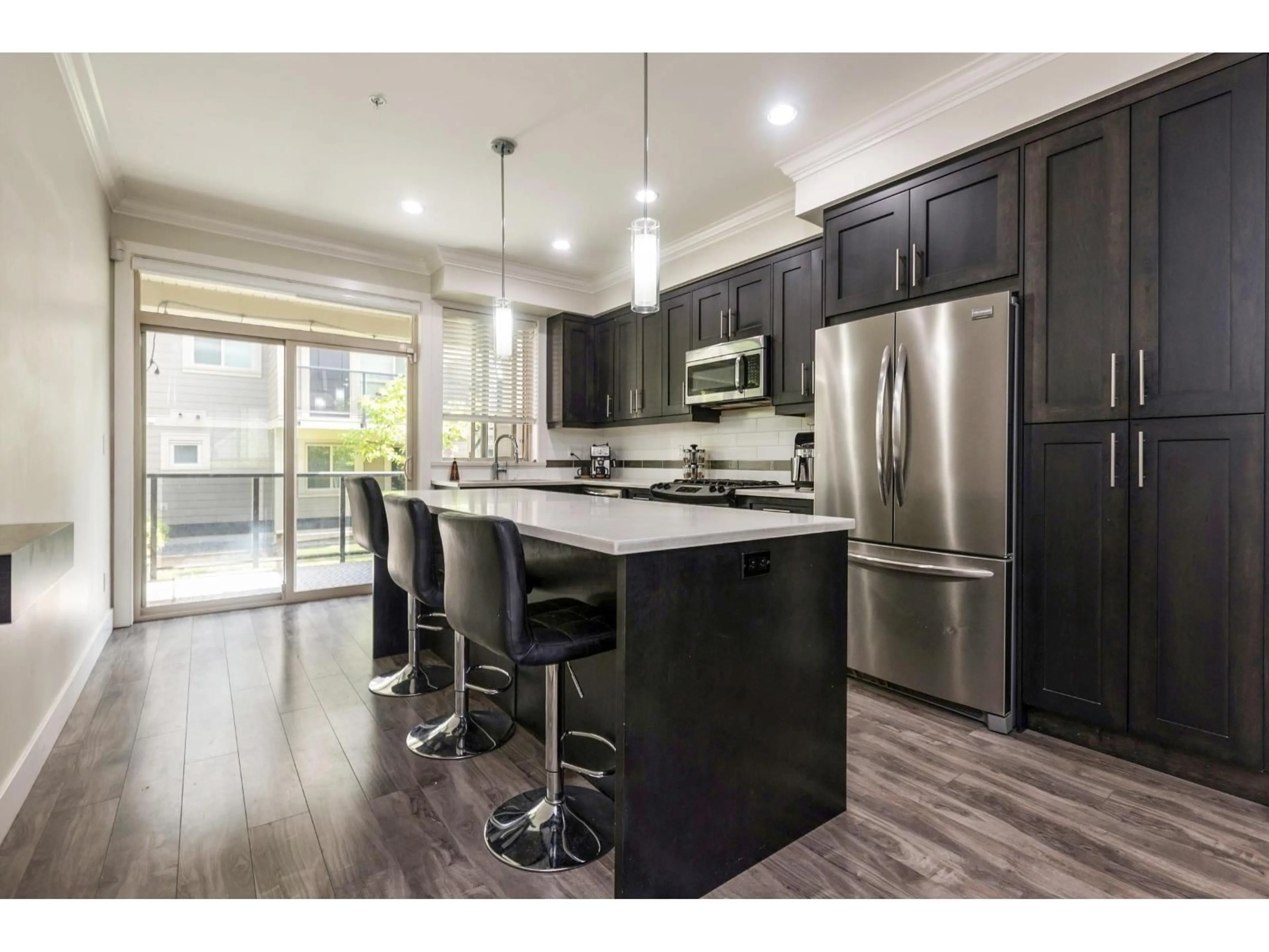 Open concept kitchen, wood/laminate floor for 10 - 19913 70, Langley British Columbia V2Y0S9