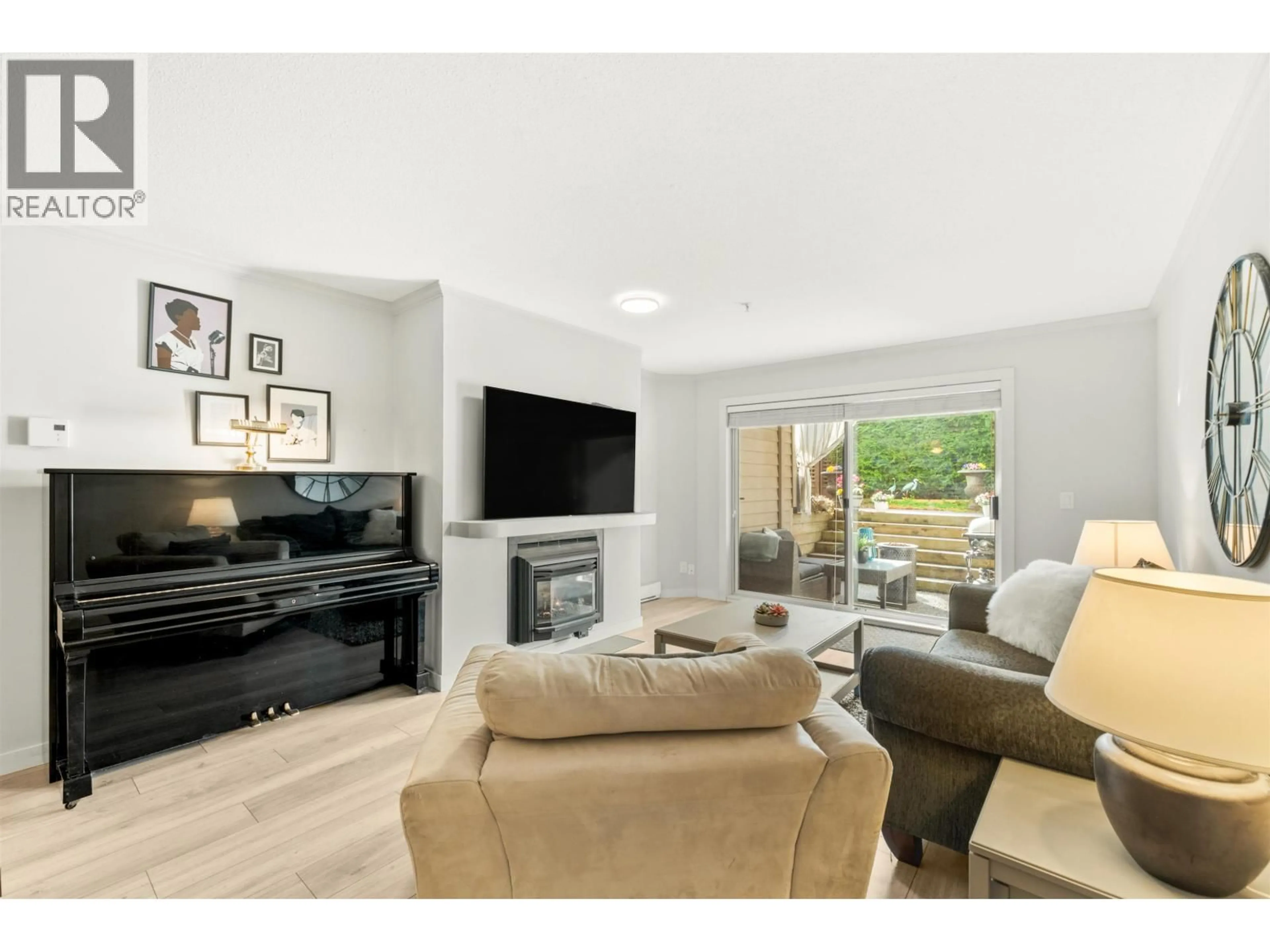 Living room with furniture, wood/laminate floor for 305 - 1050 BOWRON COURT, North Vancouver British Columbia V7H2X6