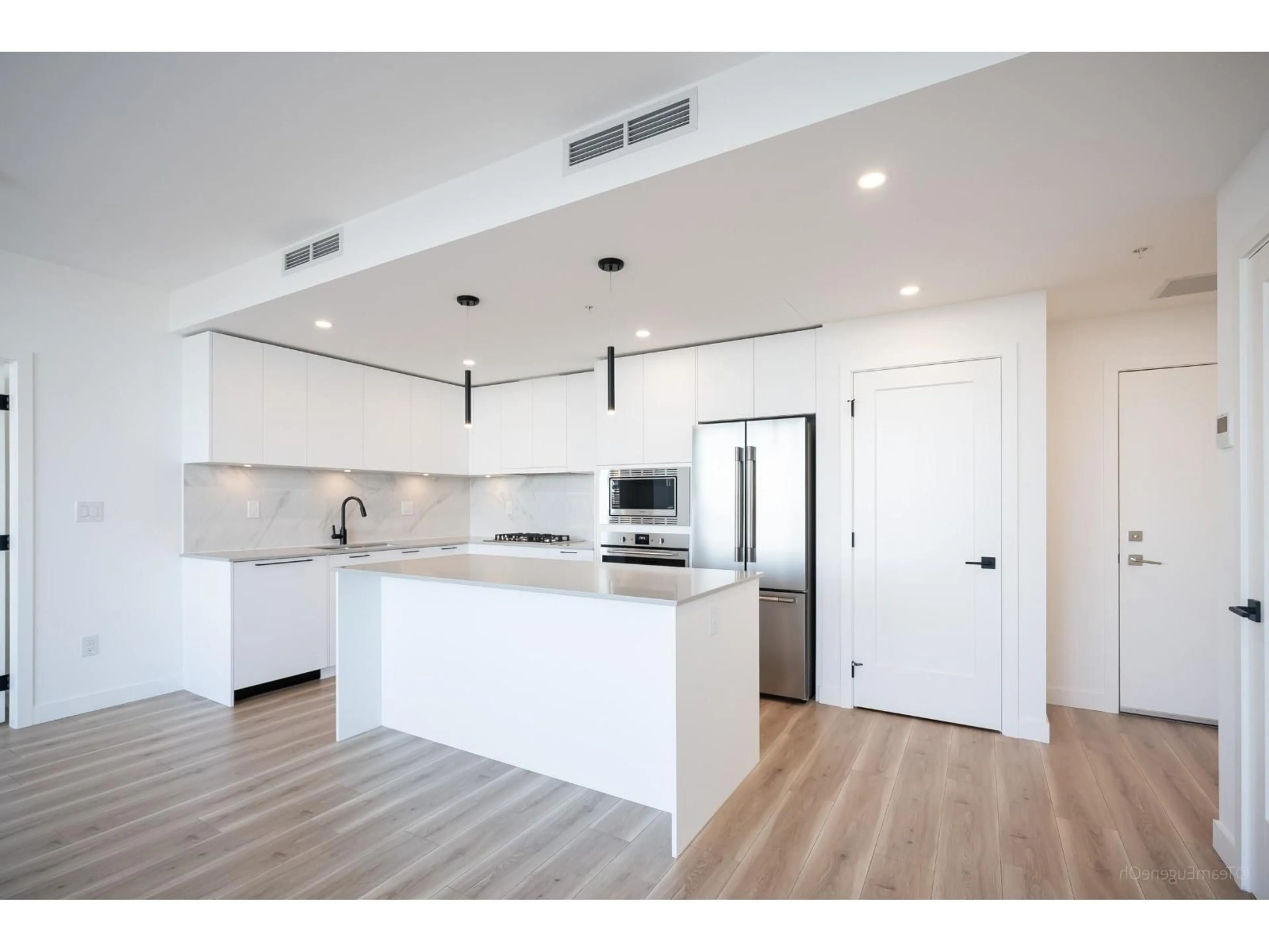Open concept kitchen, wood/laminate floor for 904 - 20065 85, Langley British Columbia V2Y3K4