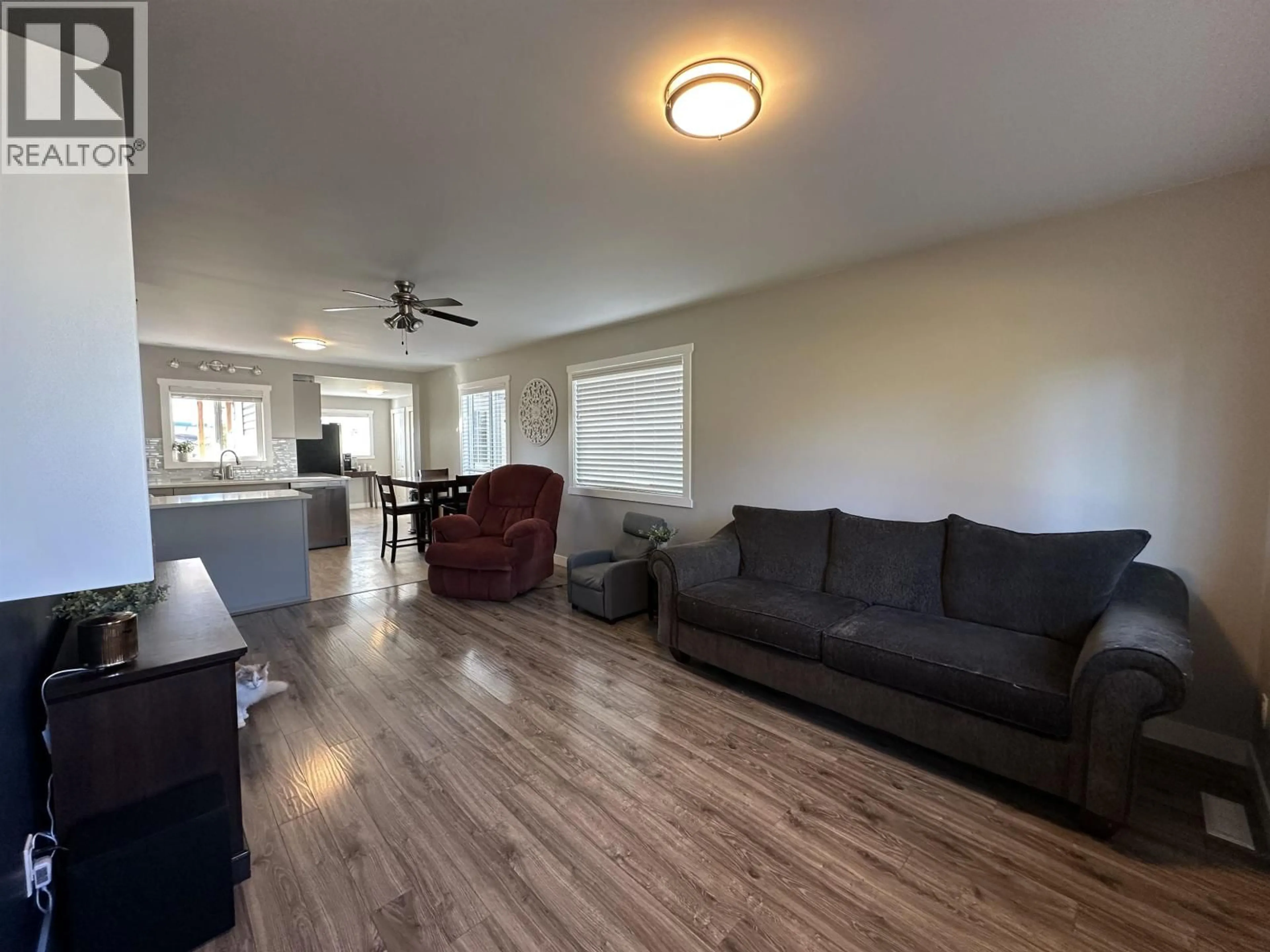 Living room with furniture, wood/laminate floor for 9615 97 AVENUE, Fort St. John British Columbia V1J1N2