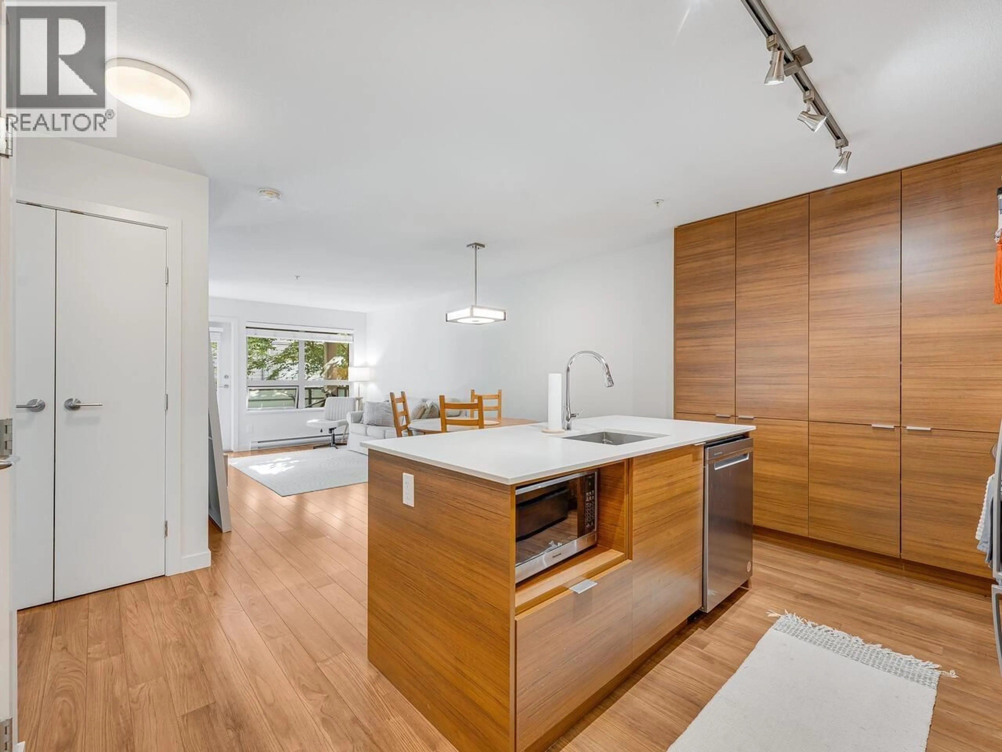 Open concept kitchen, wood/laminate floor for 313 - 1677 LLOYD AVENUE, North Vancouver British Columbia V7P0B1