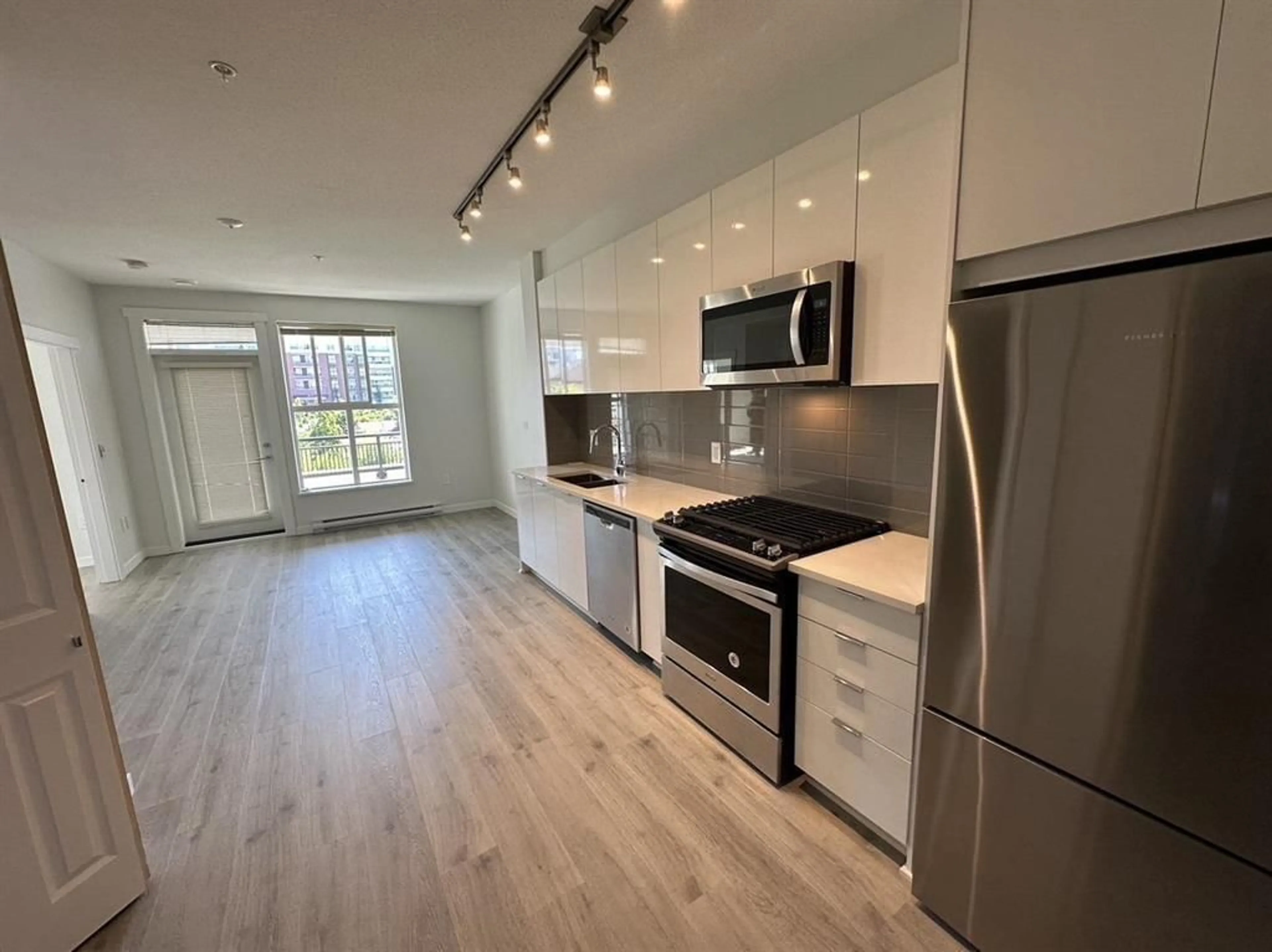 Open concept kitchen, wood/laminate floor for A201 - 8150 207, Langley British Columbia V2Y4J2