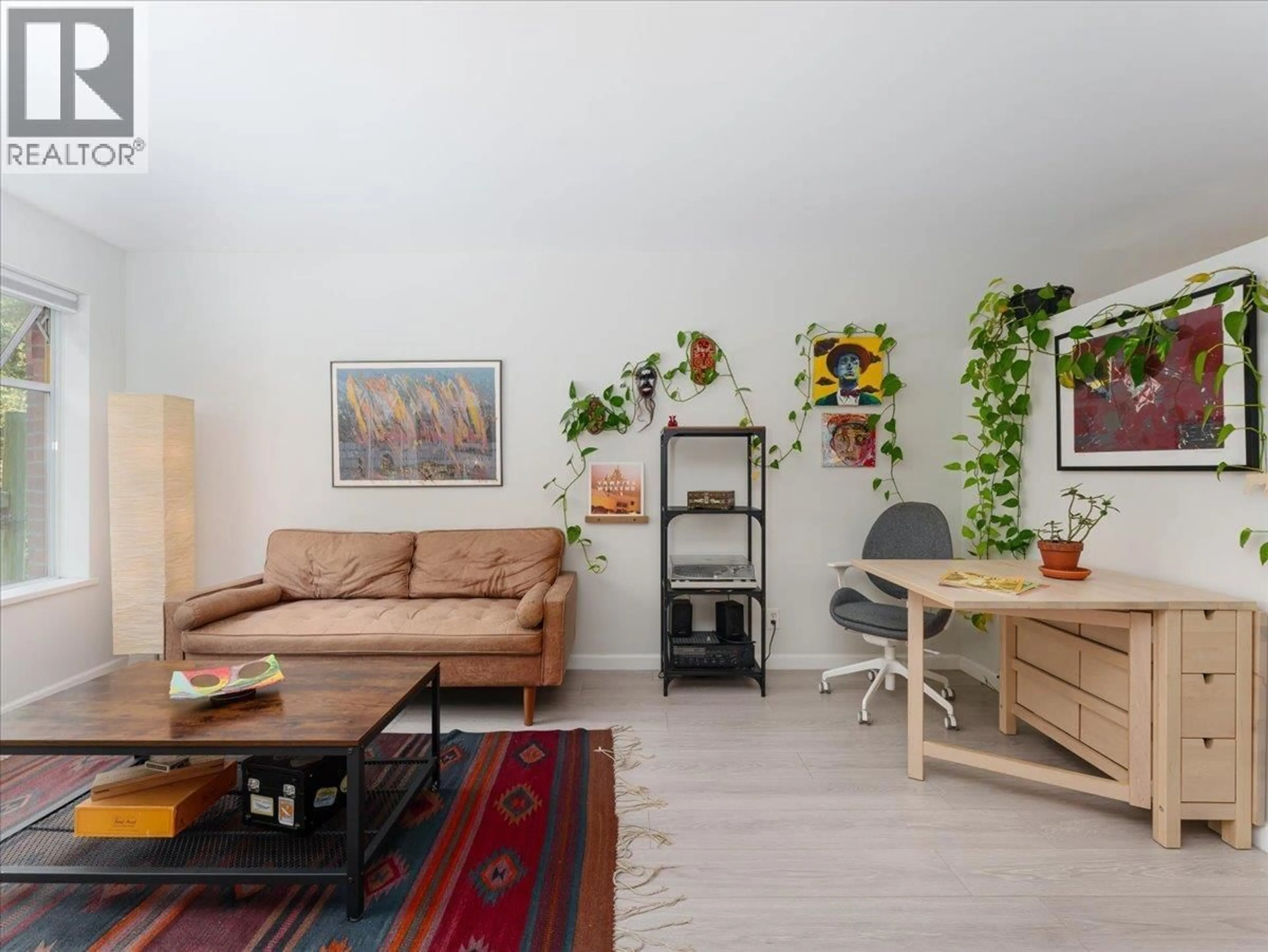Living room with furniture, wood/laminate floor for 205 - 663 GORE AVENUE, Vancouver British Columbia V6A2Z8