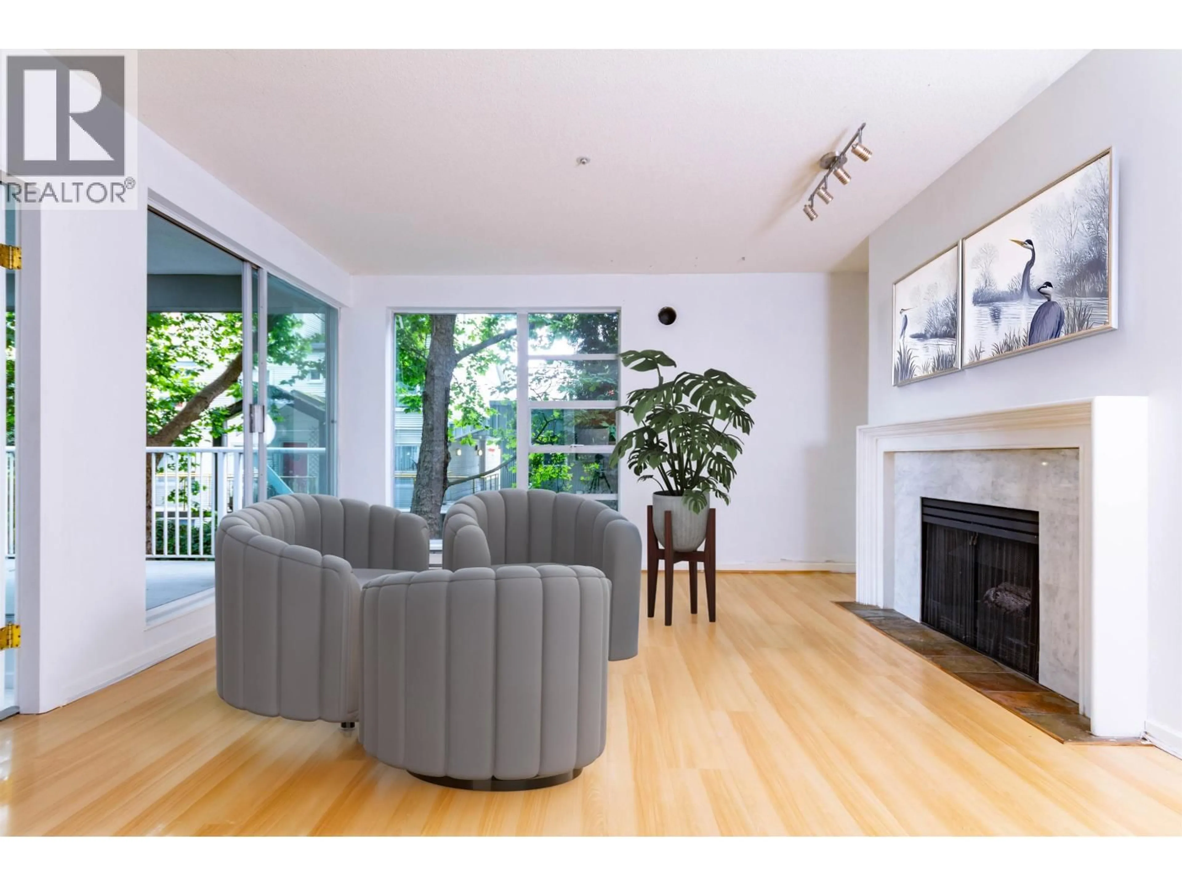 Living room with furniture, wood/laminate floor for 202 - 1820 KENT AVENUE, Vancouver British Columbia V5P2S7