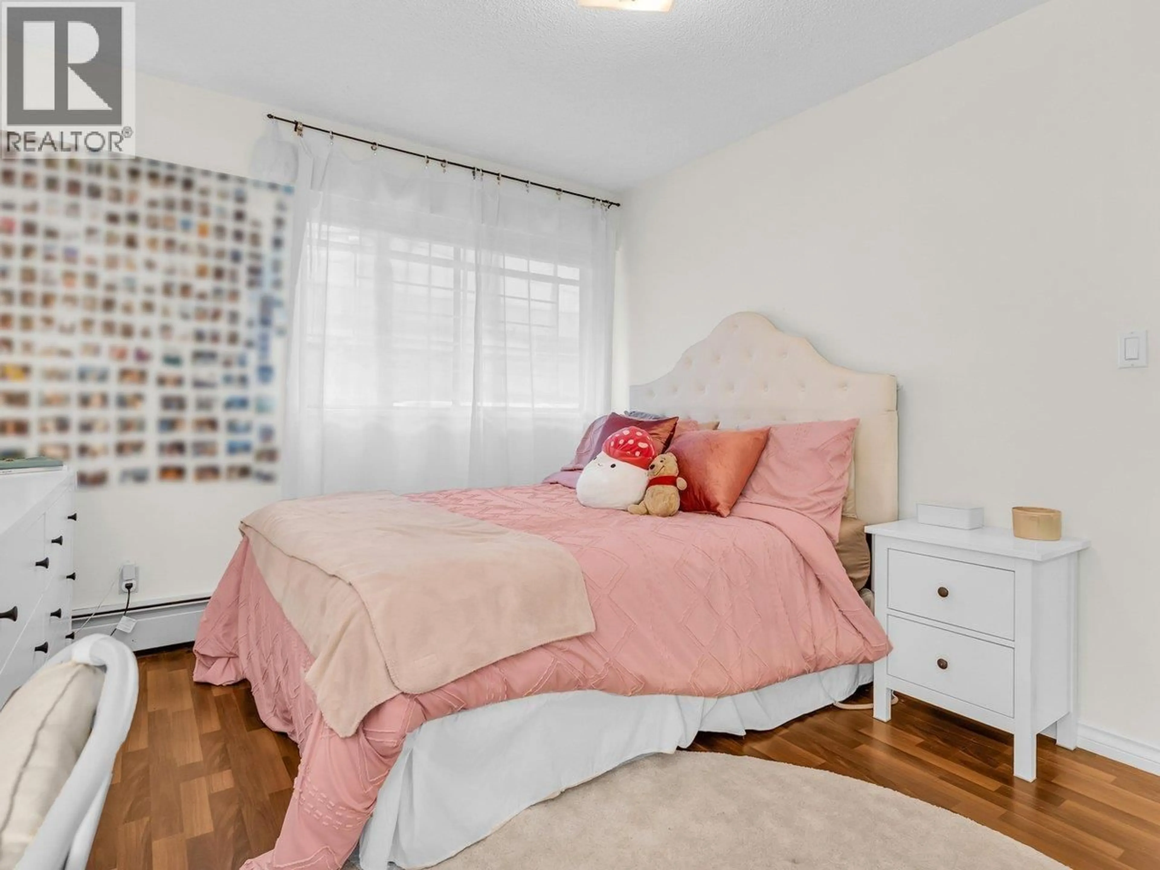 Bedroom with bed, wood/laminate floor for 103 - 2190 8TH AVENUE, Vancouver British Columbia V6K2A4
