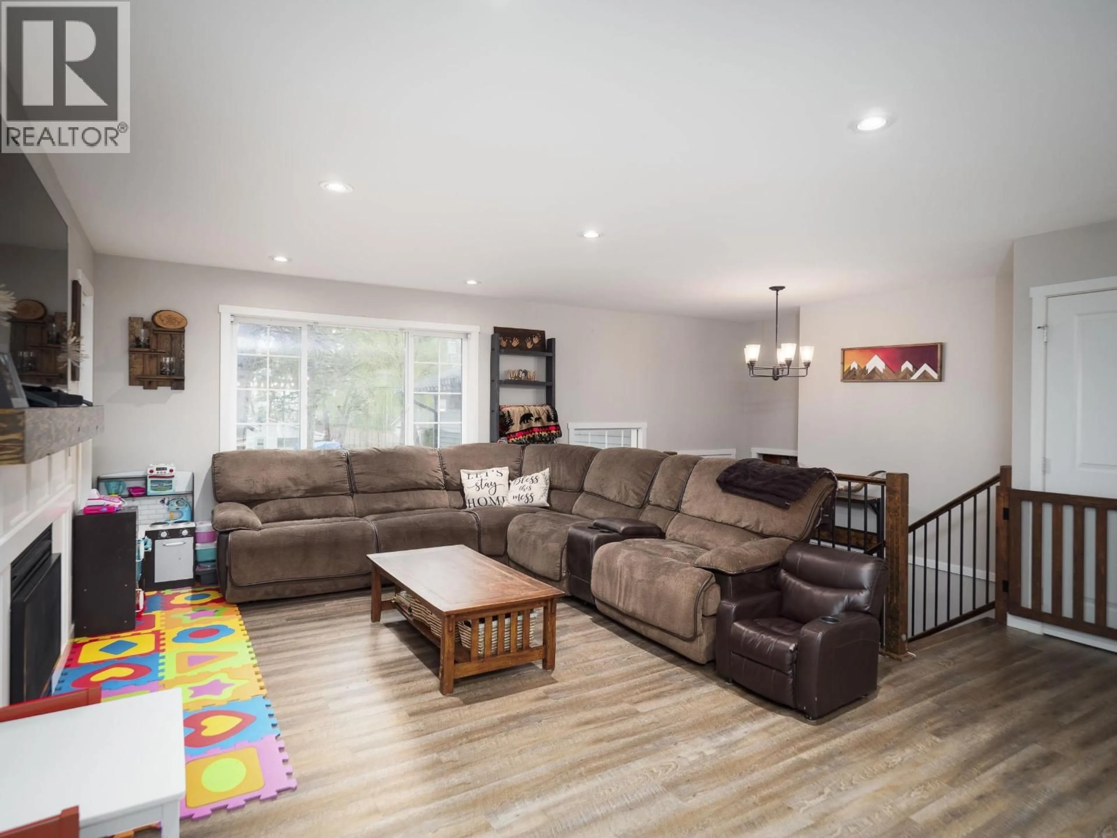 Living room with furniture, wood/laminate floor for 8249 PETER ROAD, Prince George British Columbia V2K0B2