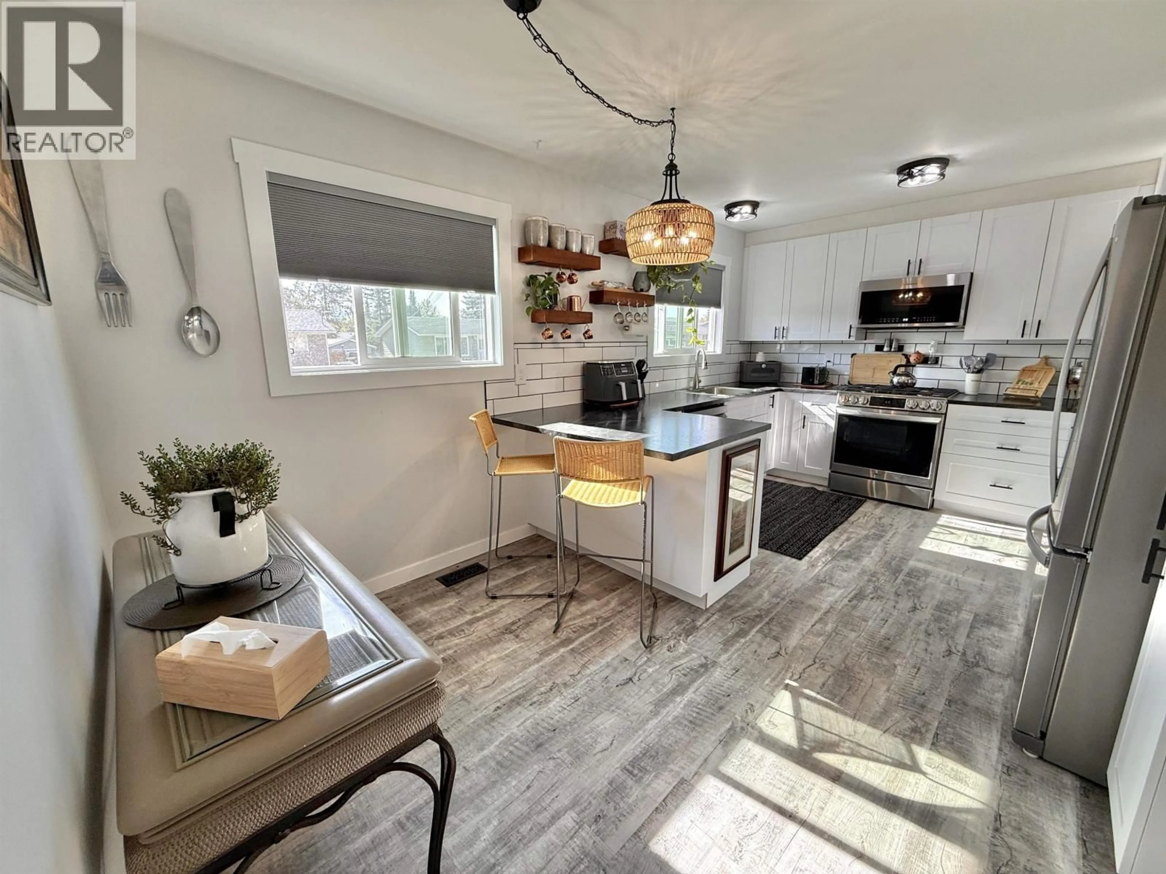 Open concept kitchen, wood/laminate floor for 580 NASON STREET, Quesnel British Columbia V2J3A1