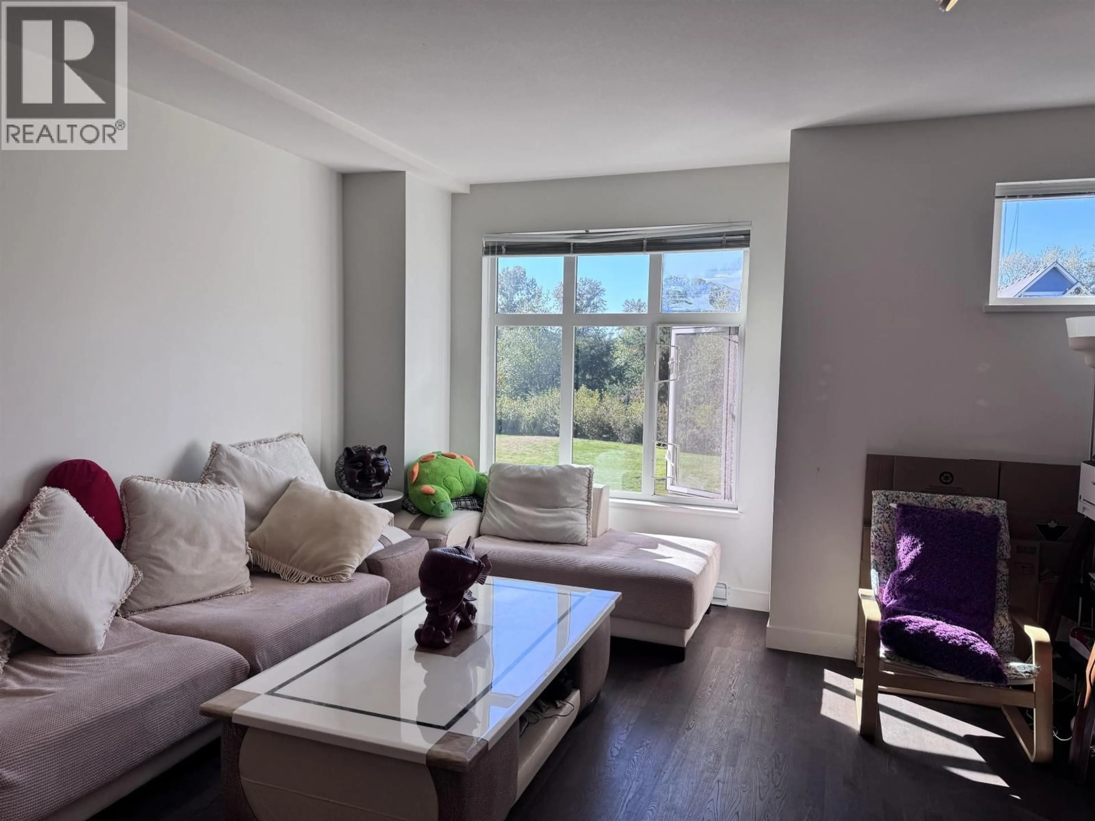 Living room with furniture, wood/laminate floor for 406 - 8485 NEW HAVEN CLOSE, Burnaby British Columbia V5J0B7