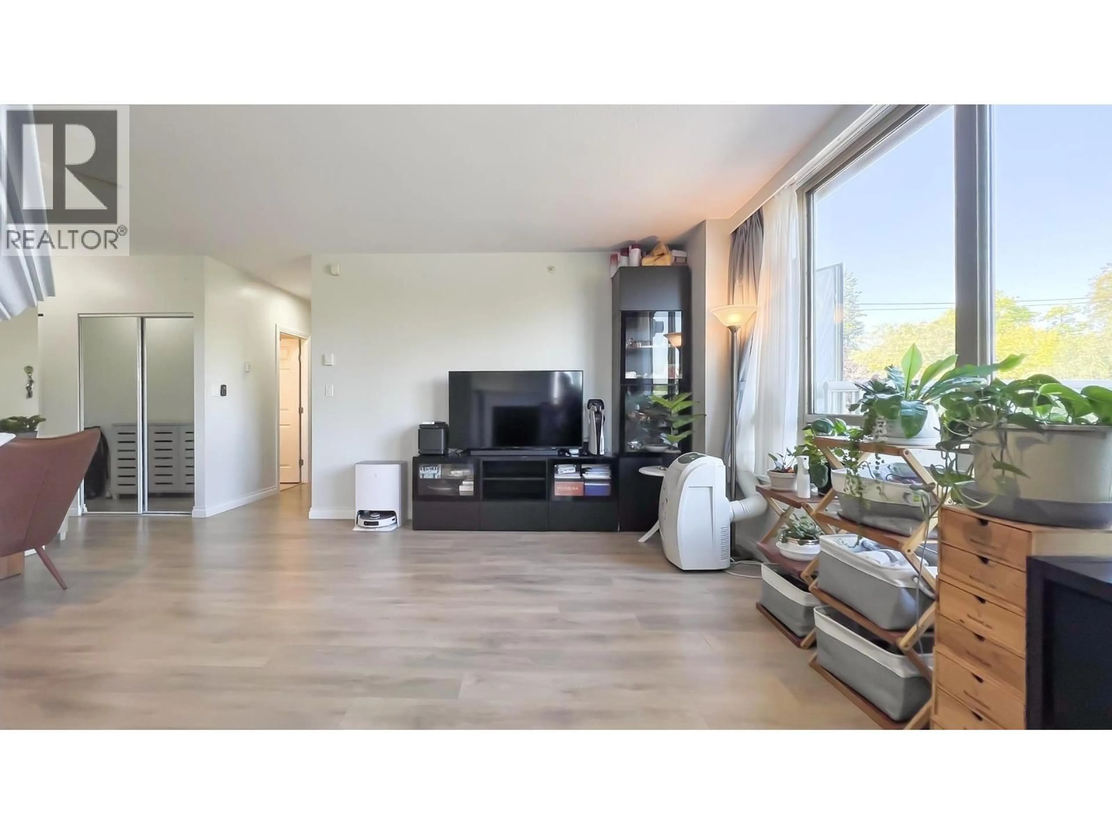 Living room with furniture, wood/laminate floor for 202 - 2580 TOLMIE STREET, Vancouver British Columbia V6R4R4