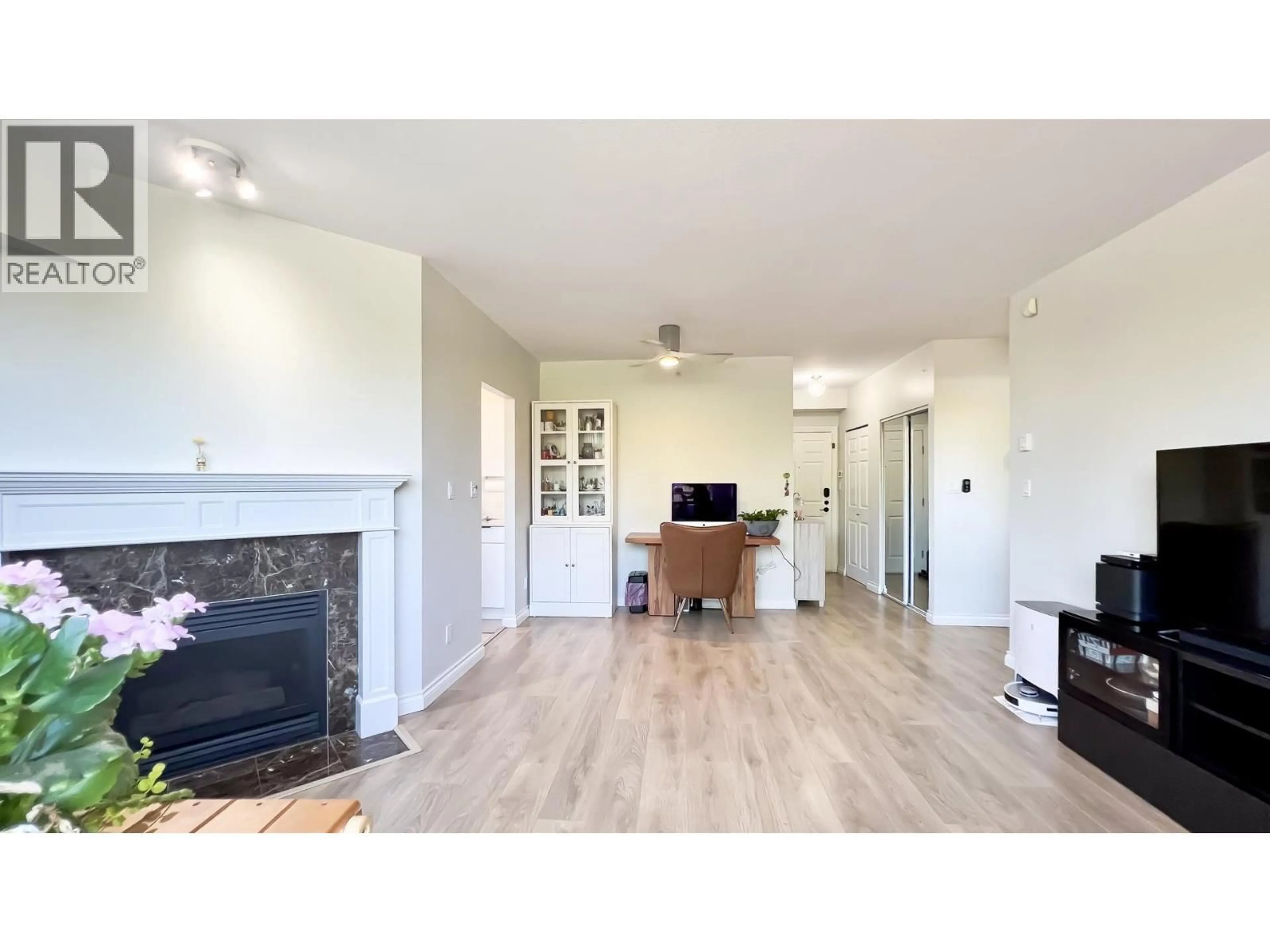 Living room with furniture, wood/laminate floor for 202 - 2580 TOLMIE STREET, Vancouver British Columbia V6R4R4