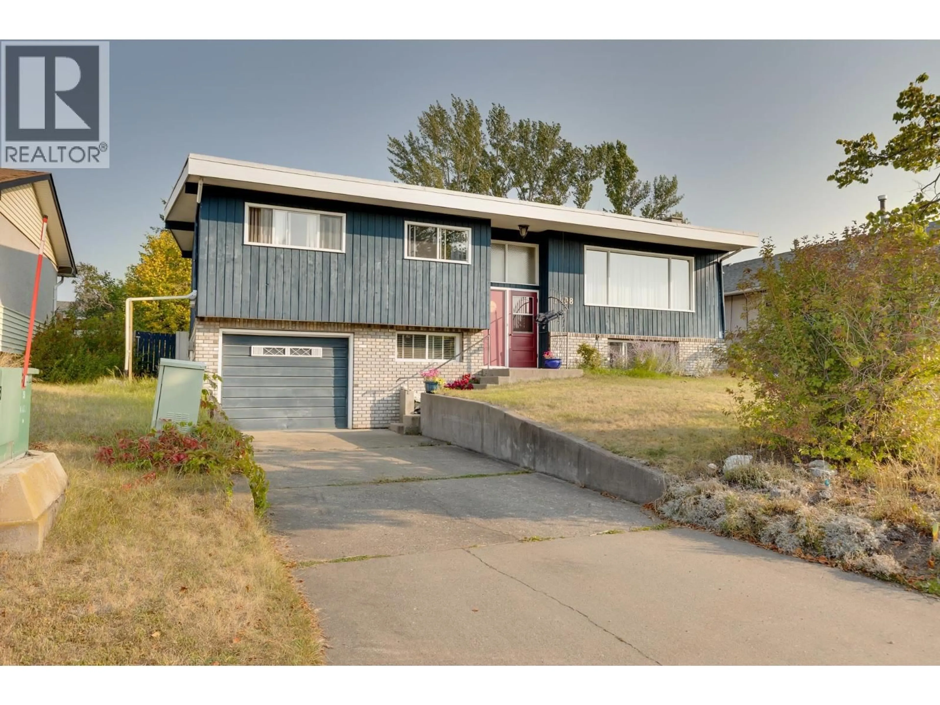 Home with vinyl exterior material, street for 1408 FRASER CRESCENT, Prince George British Columbia V2M3Y2