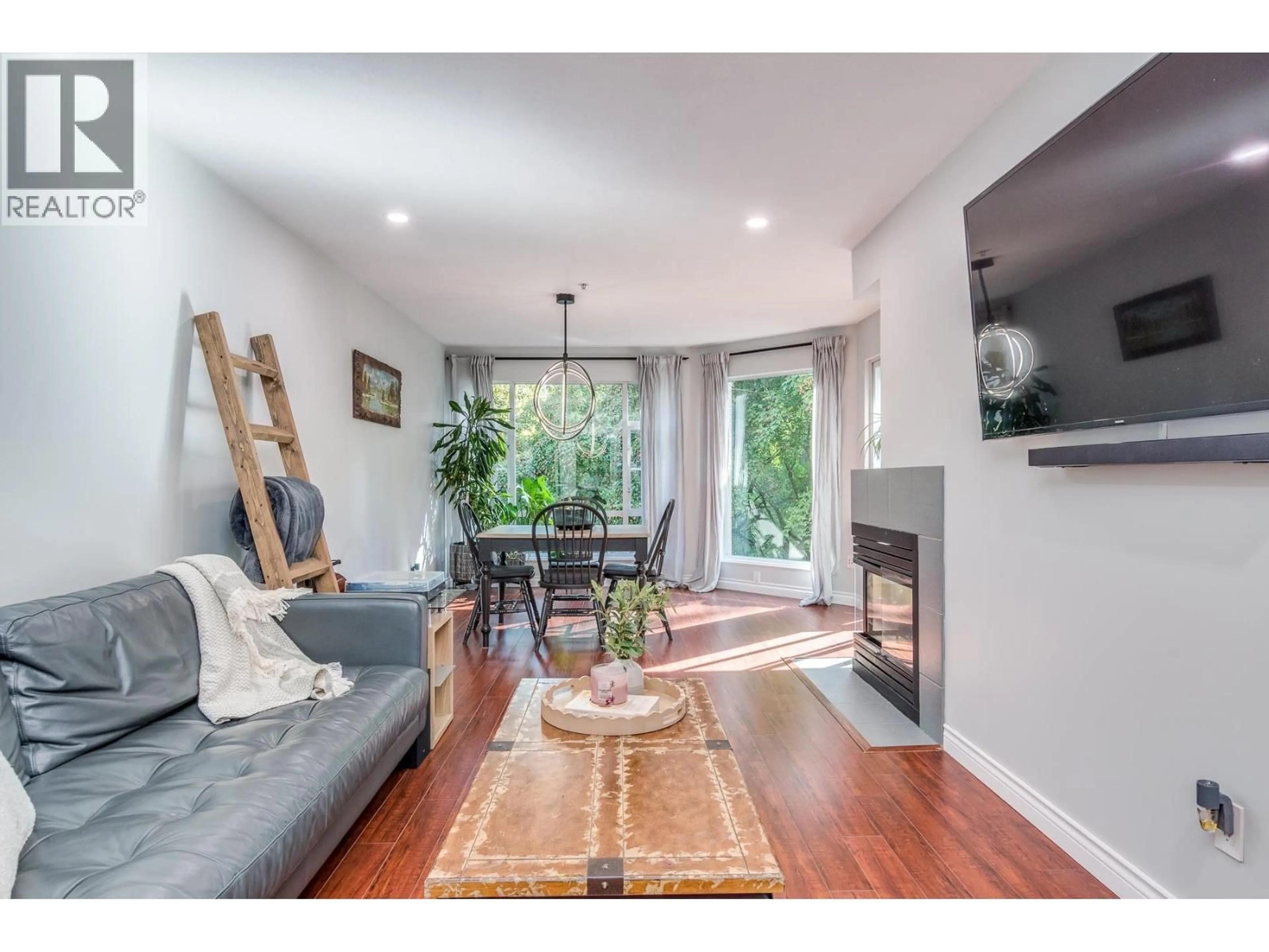 Living room with furniture, wood/laminate floor for 212 - 22233 RIVER ROAD, Maple Ridge British Columbia V2X3N7