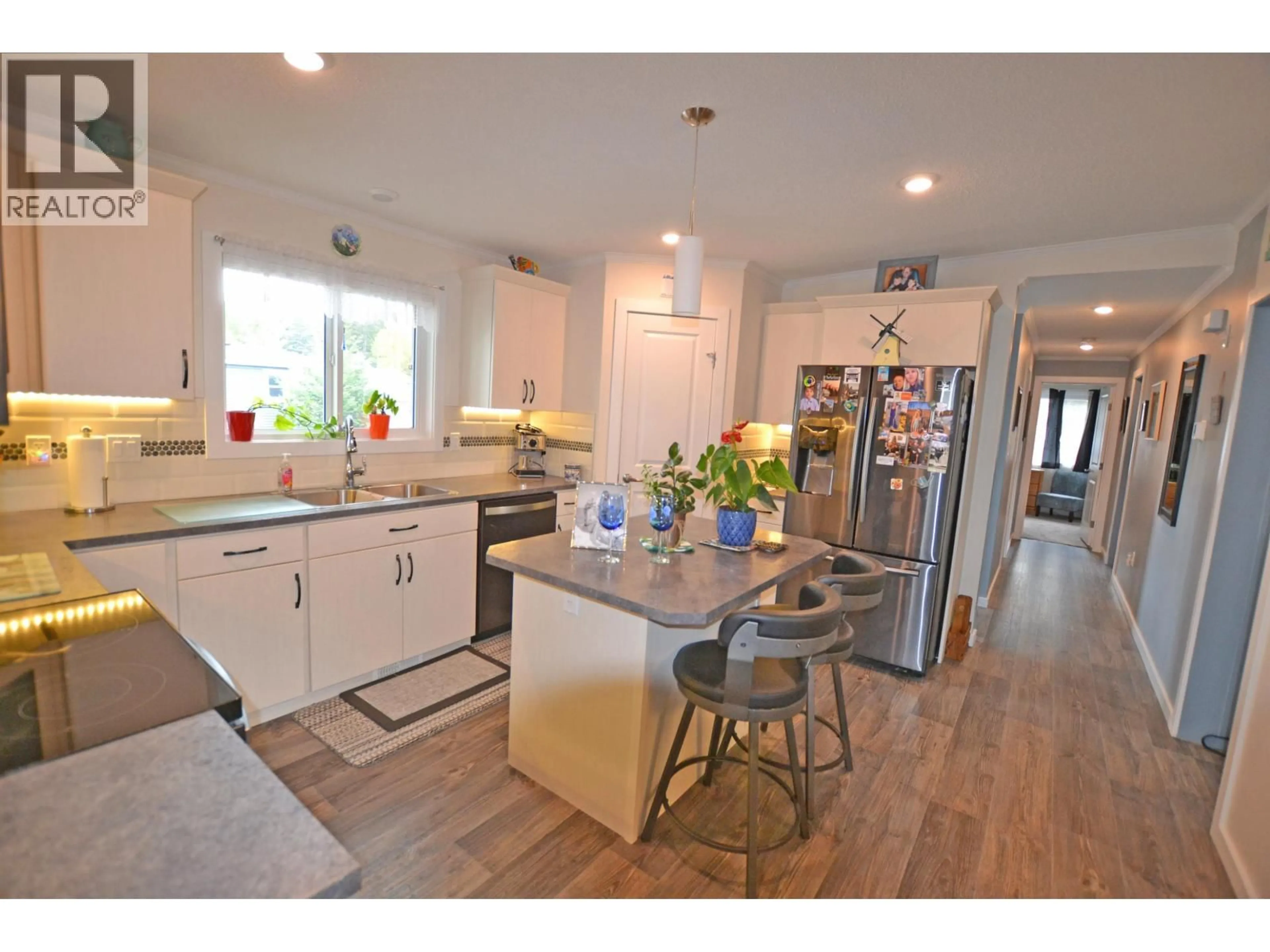 Open concept kitchen, wood/laminate floor for 31 4072 LAC LA HACHE STATION ROAD, 100 Mile House British Columbia V0K1T0