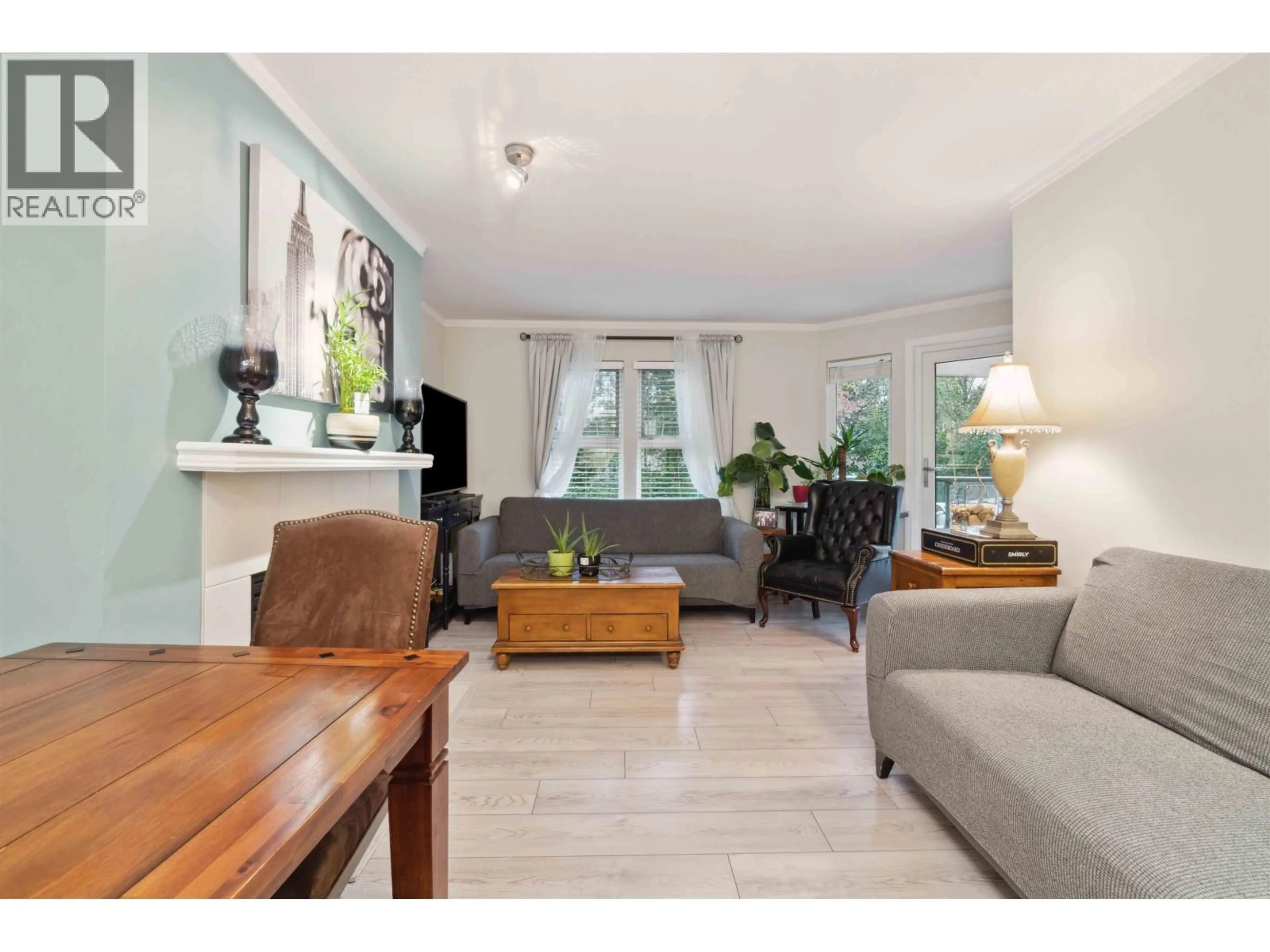 Living room with furniture, wood/laminate floor for 107 - 99 BEGIN STREET, Coquitlam British Columbia V3K6R5