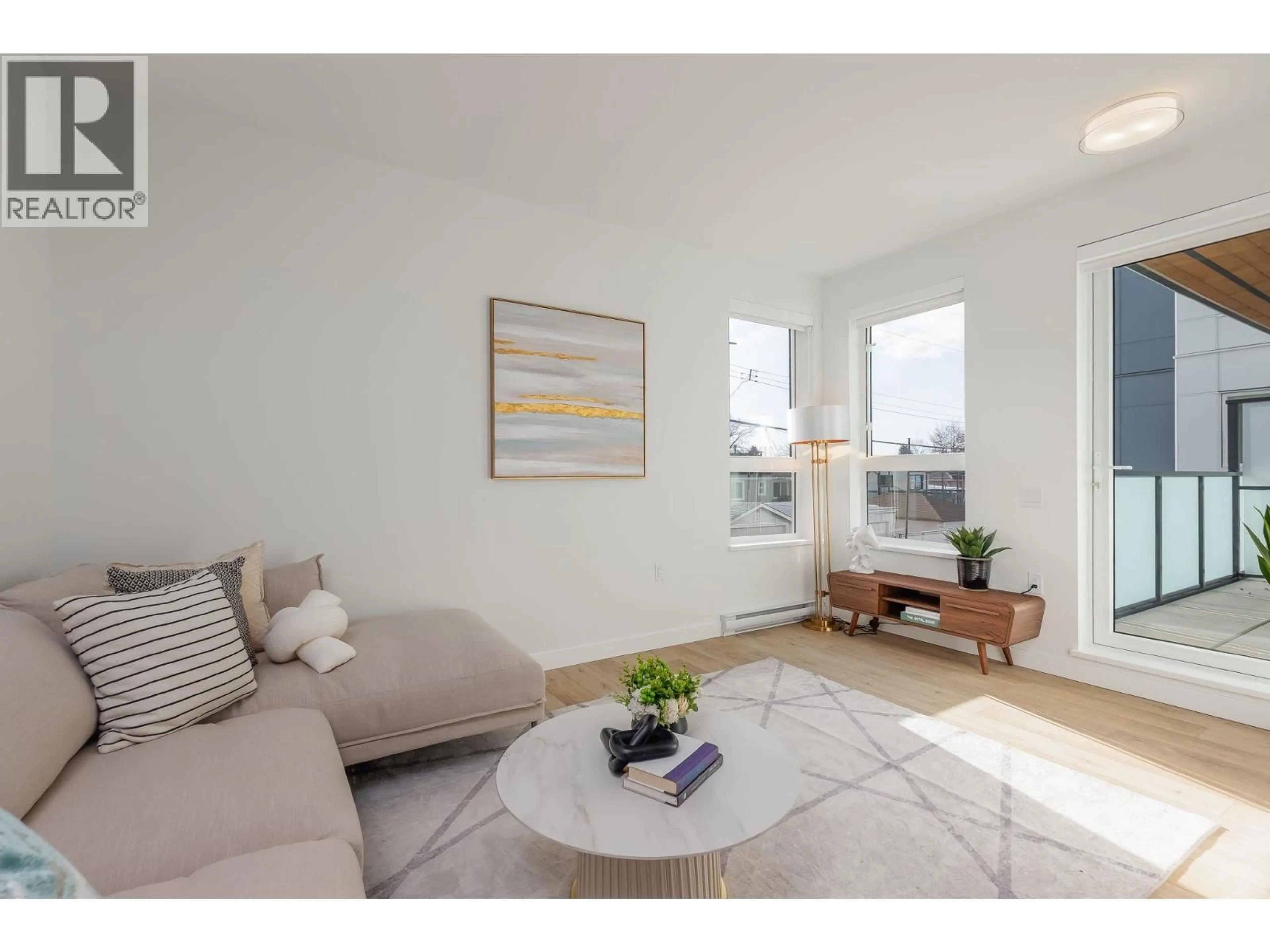 Living room with furniture, wood/laminate floor for 203 - 4933 CLARENDON STREET, Vancouver British Columbia V5R0J6