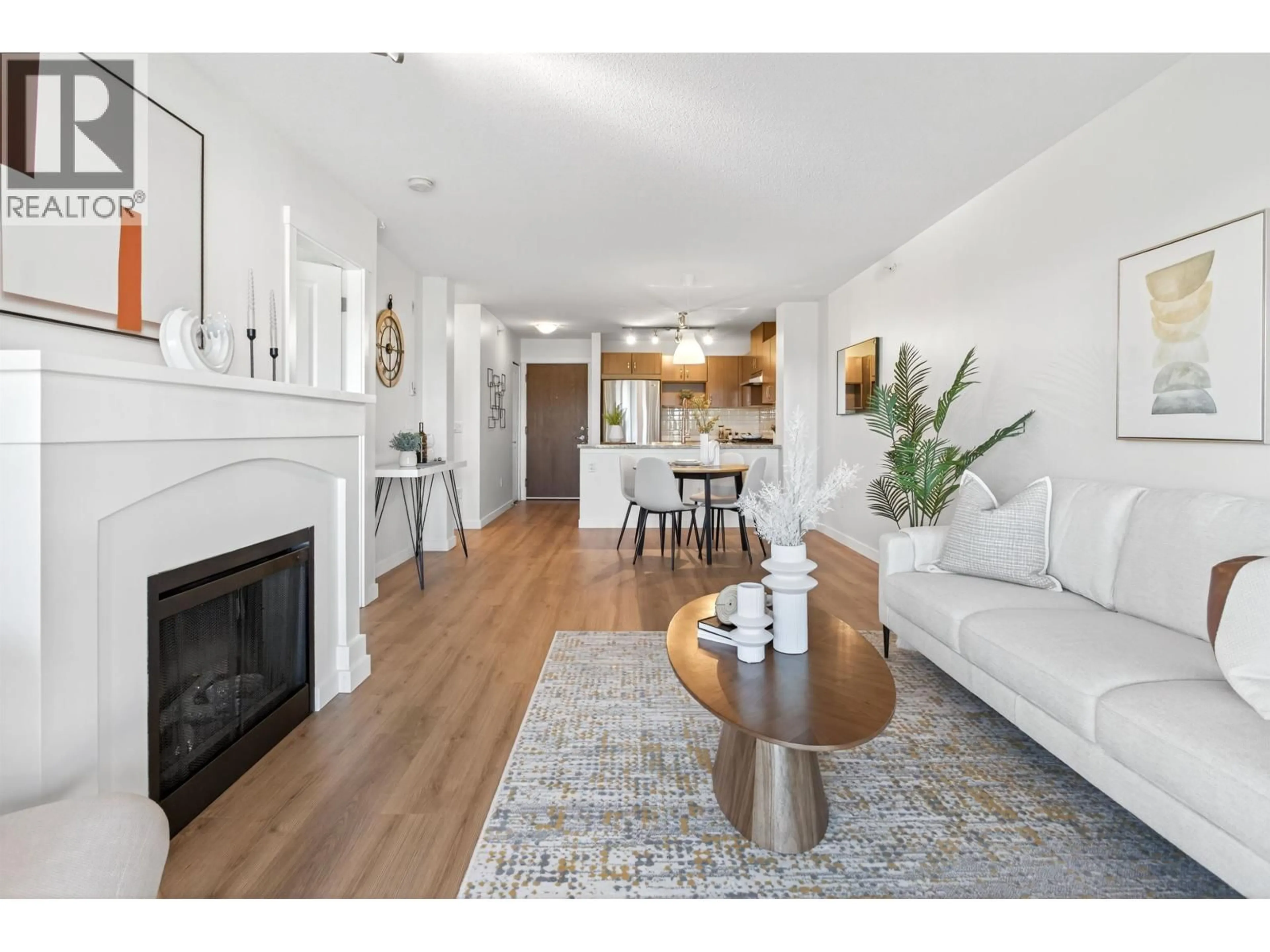 Living room with furniture, wood/laminate floor for 411 - 3110 DAYANEE SPRINGS BOULEVARD, Coquitlam British Columbia V3E0B4