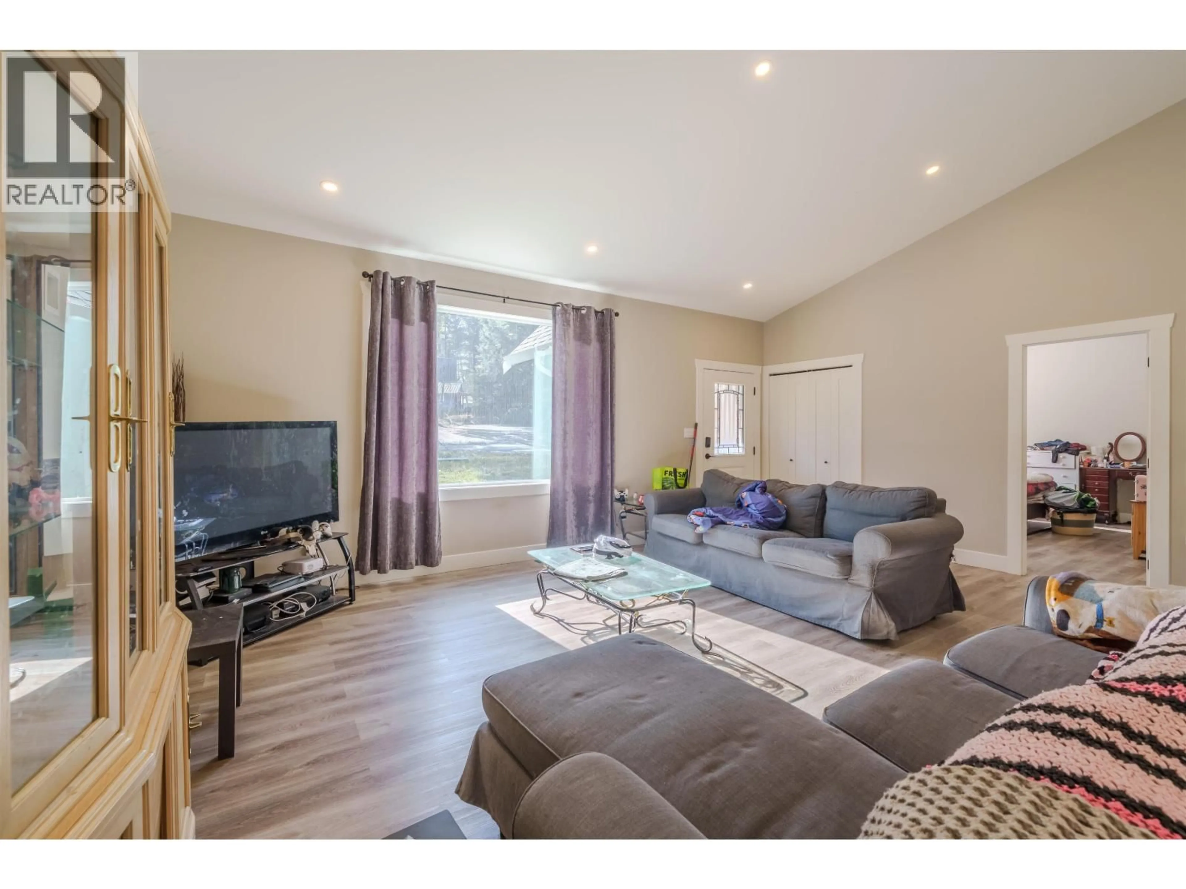 Living room with furniture, wood/laminate floor for 5025 KYLLO ROAD, 108 Mile Ranch British Columbia V0K2Z0