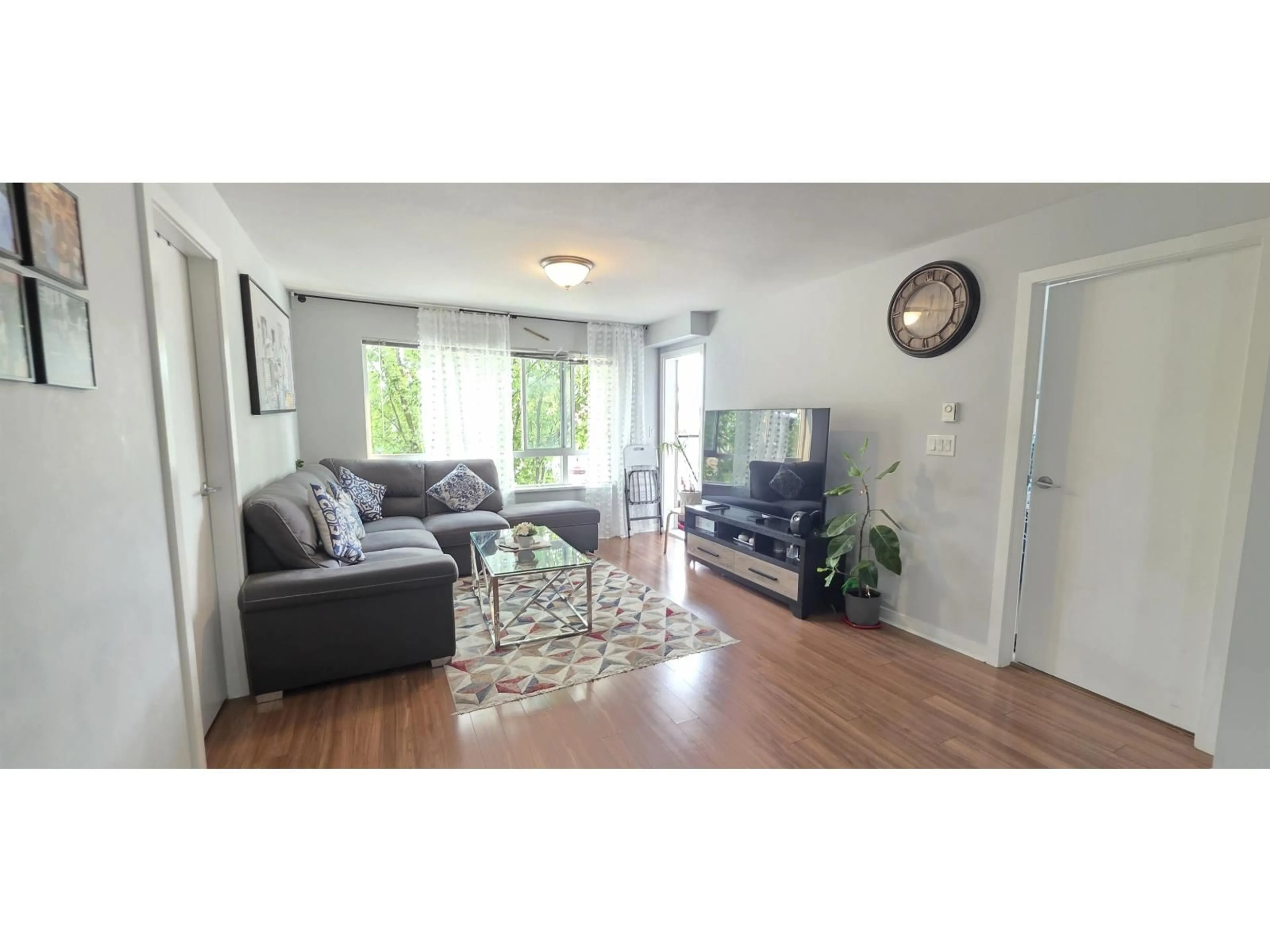 Living room with furniture, wood/laminate floor for 212 - 7511 120, Delta British Columbia V4C0C1