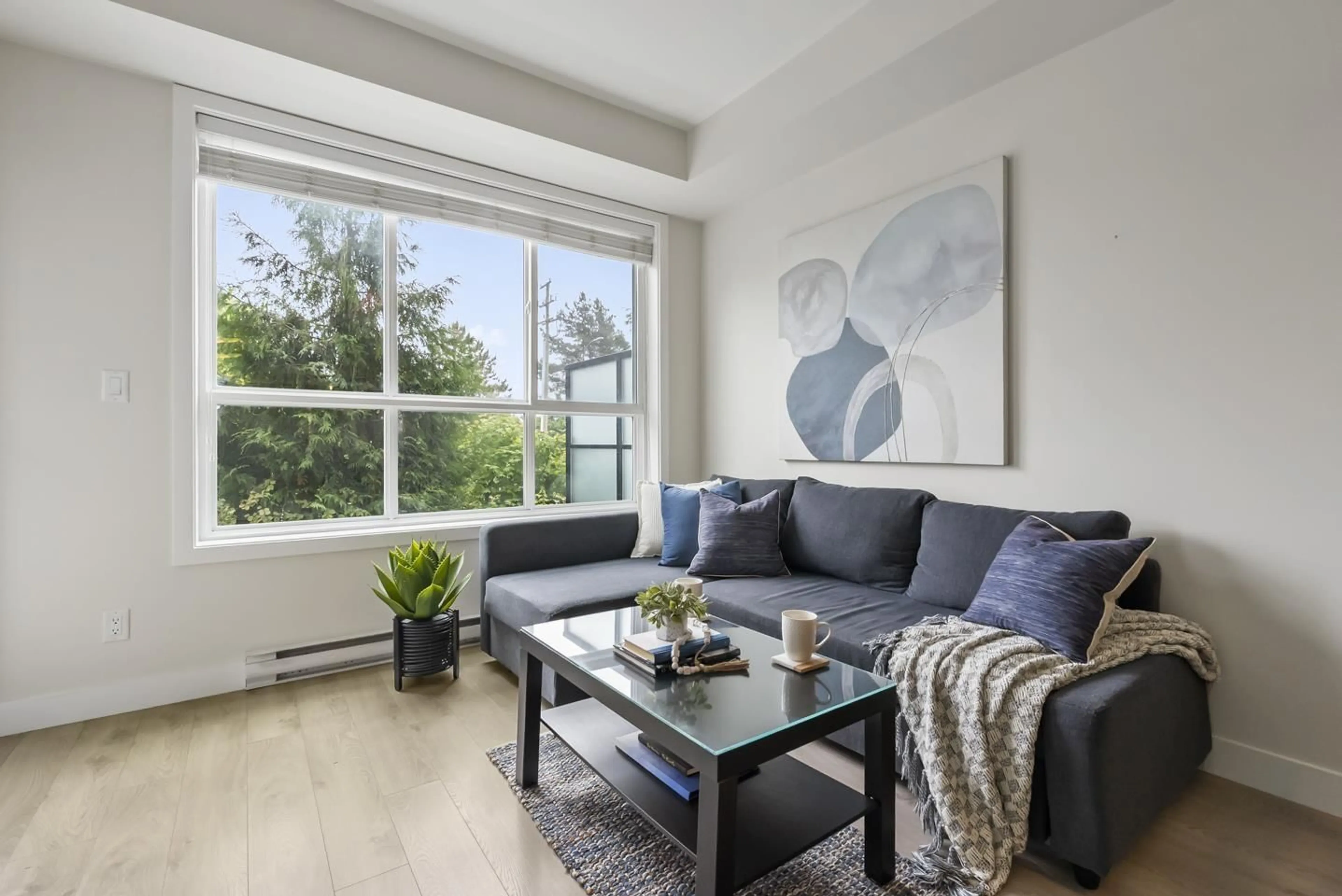Living room with furniture, wood/laminate floor for 105 - 6438 195A, Surrey British Columbia V4N6R5