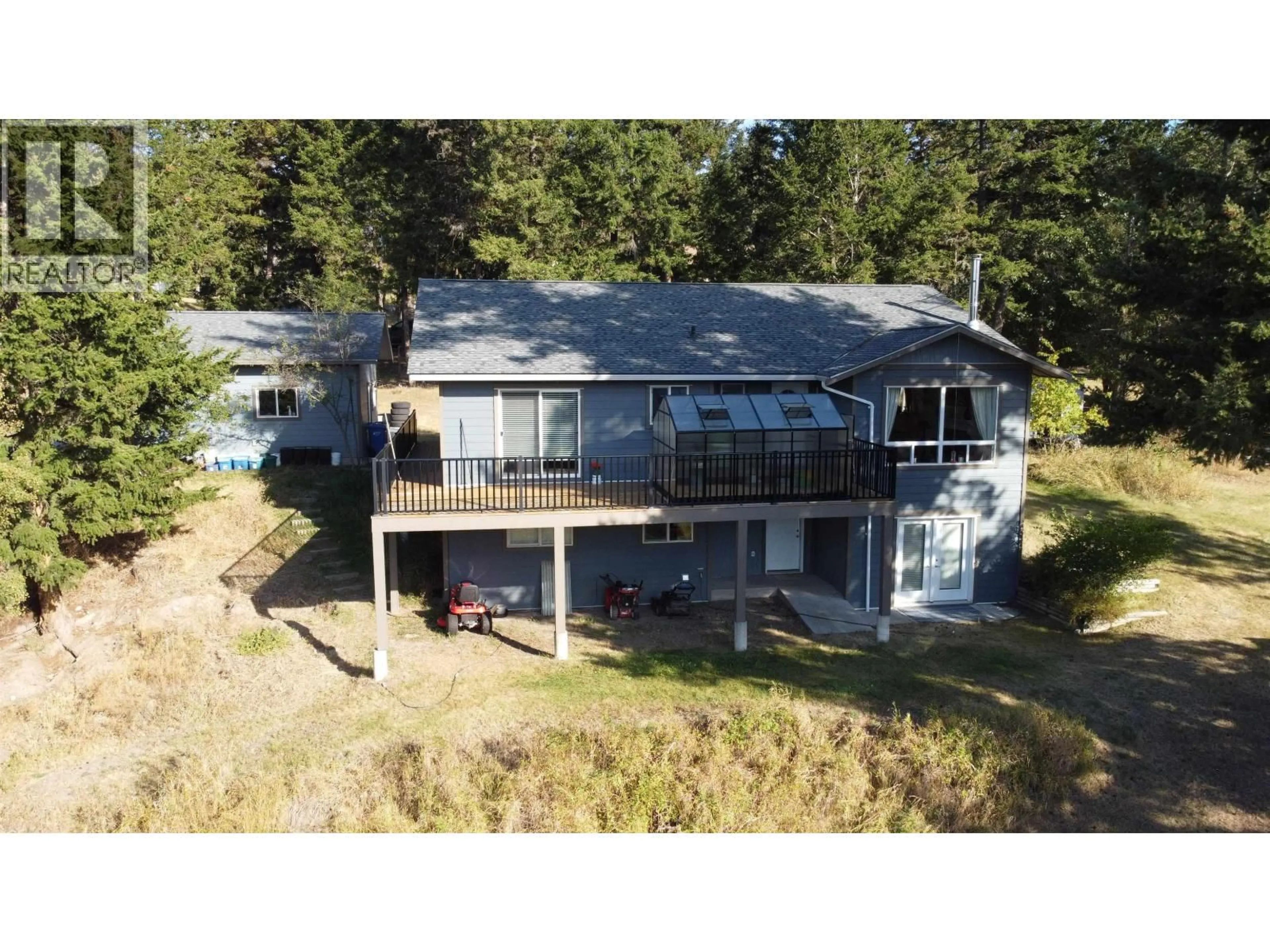 A pic from outside/outdoor area/front of a property/back of a property/a pic from drone, water/lake/river/ocean view for 4822 KITWANGA DRIVE, 108 Mile Ranch British Columbia V0K2Z0