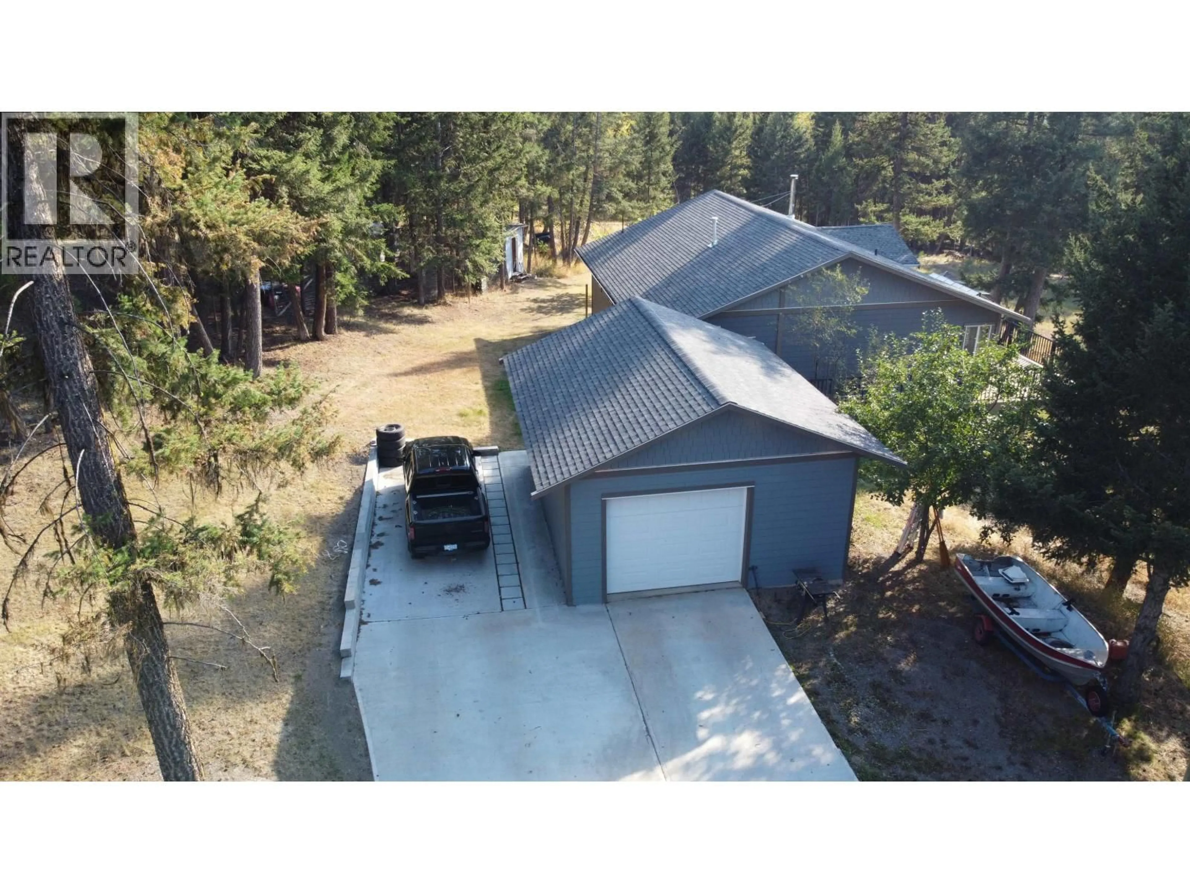 A pic from outside/outdoor area/front of a property/back of a property/a pic from drone, unknown for 4822 KITWANGA DRIVE, 108 Mile Ranch British Columbia V0K2Z0