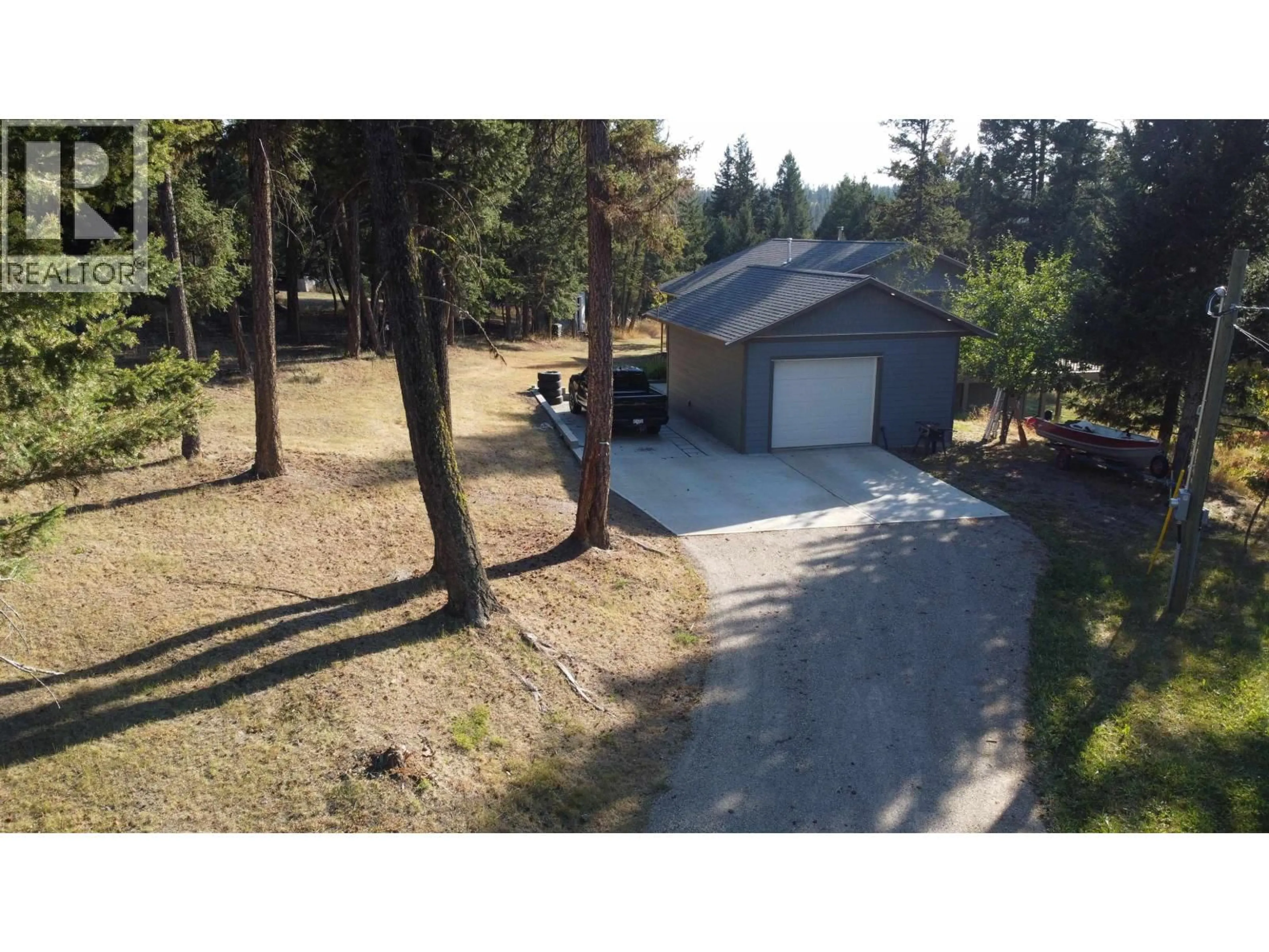 A pic from outside/outdoor area/front of a property/back of a property/a pic from drone, unknown for 4822 KITWANGA DRIVE, 108 Mile Ranch British Columbia V0K2Z0