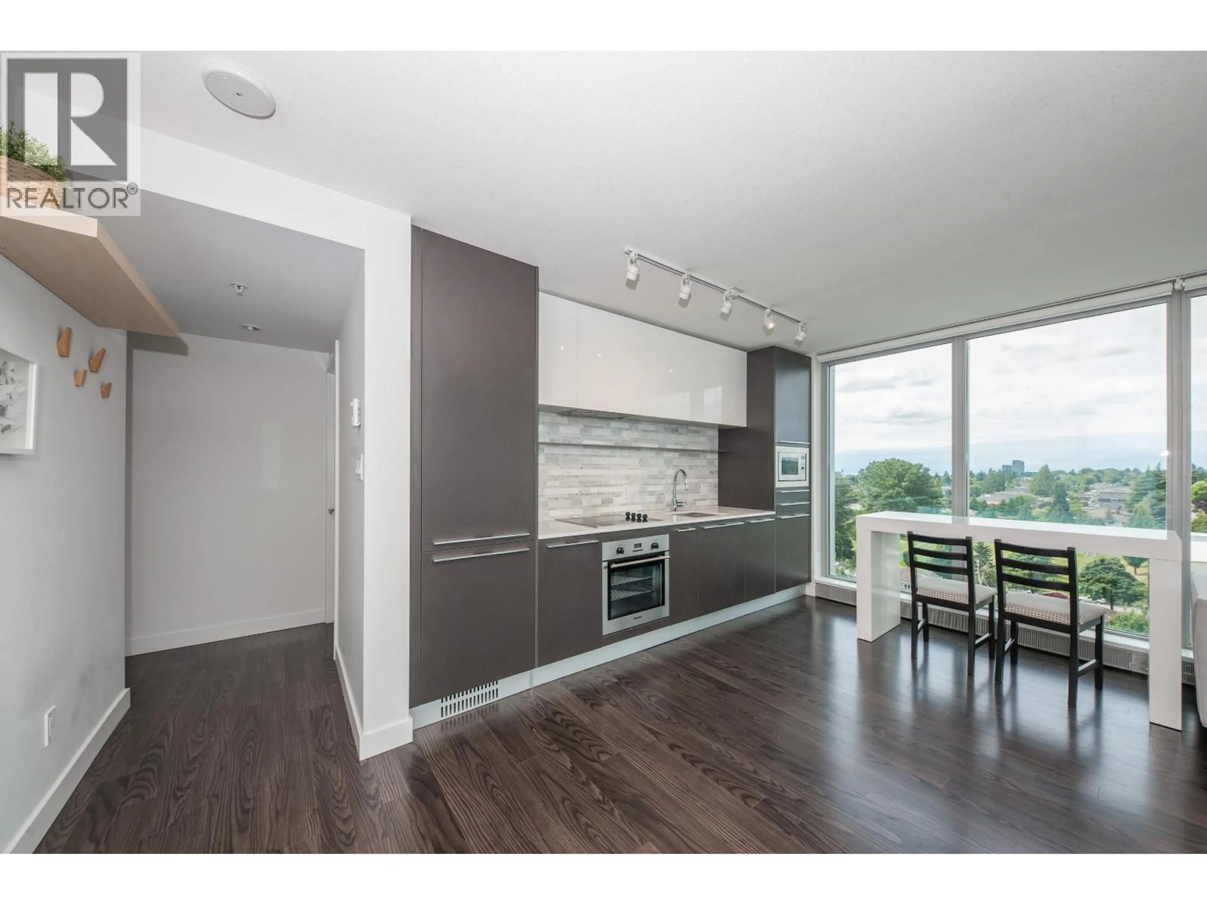 Open concept kitchen, wood/laminate floor for 1502 - 8131 NUNAVUT LANE, Vancouver British Columbia V5X0E2