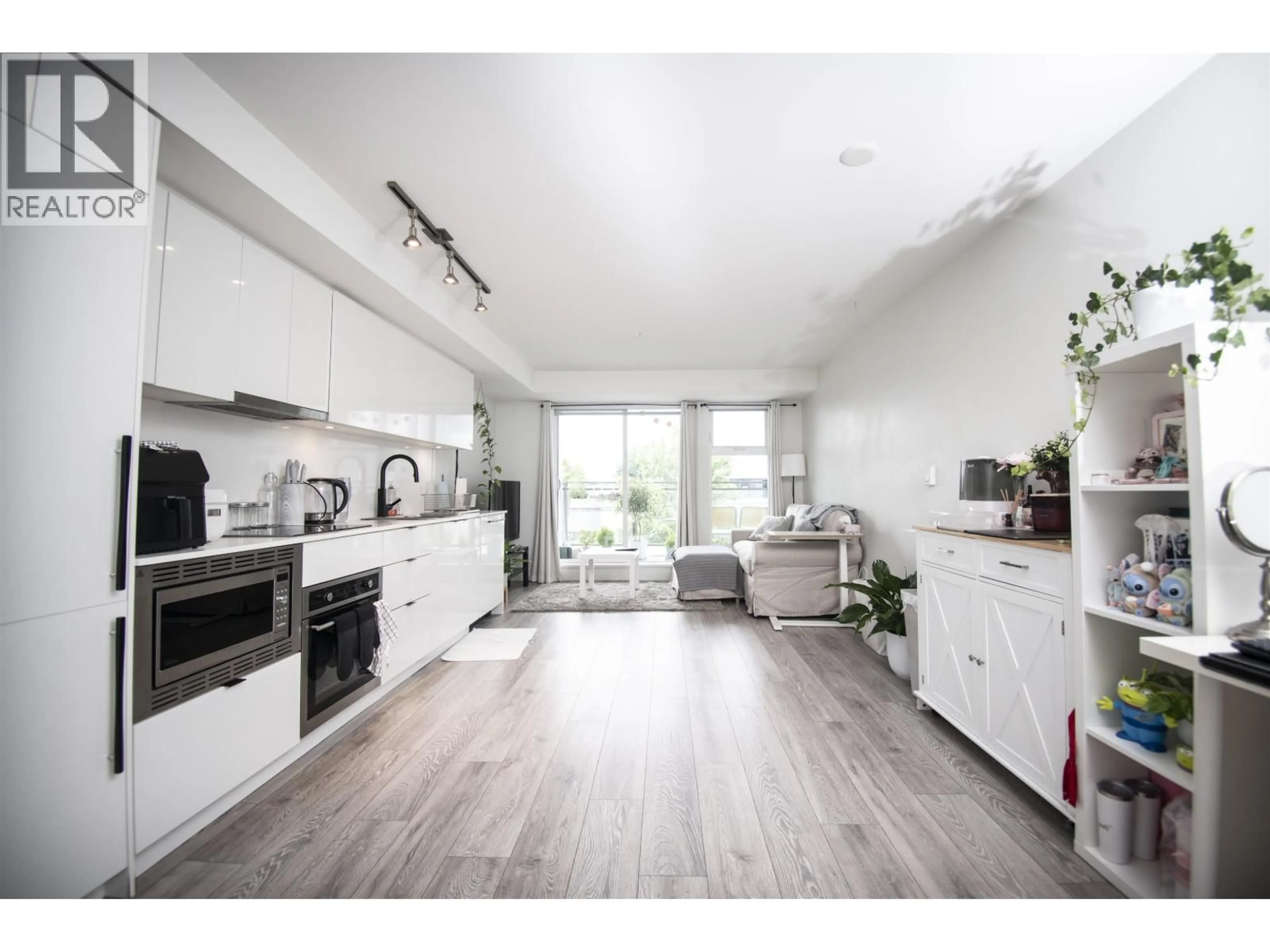 Open concept kitchen, wood/laminate floor for 216 - 630 BROADWAY, Vancouver British Columbia V5T0J1
