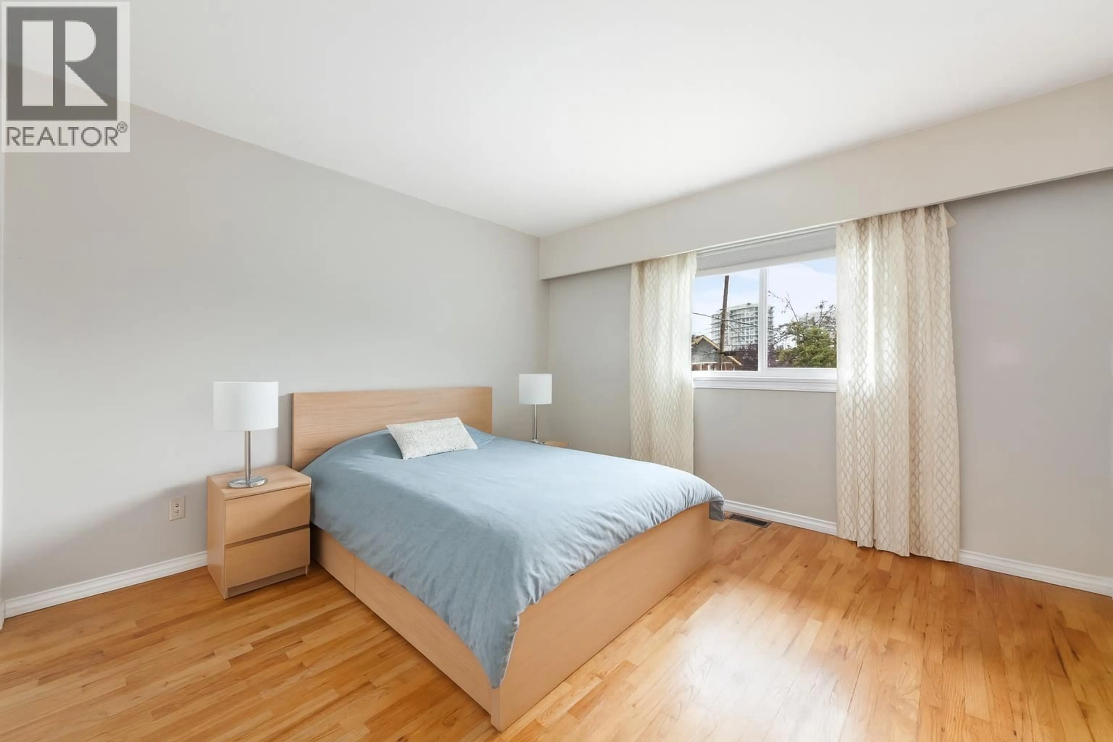 Bedroom with bed, wood/laminate floor for 4561 NANAIMO STREET, Vancouver British Columbia V5N5J5