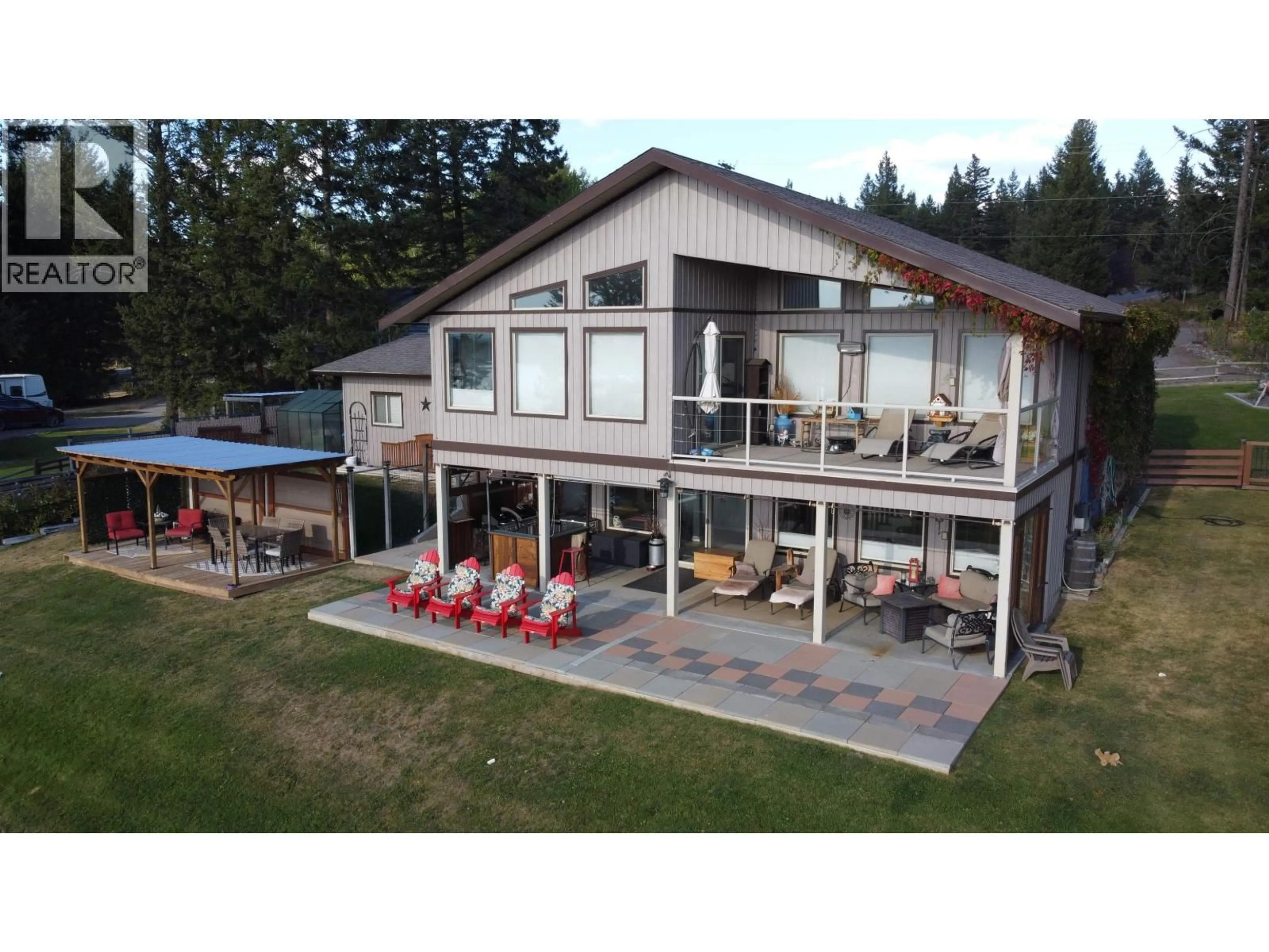 A pic from outside/outdoor area/front of a property/back of a property/a pic from drone, water/lake/river/ocean view for 4782 TELQUA DRIVE, 108 Mile Ranch British Columbia V0K2Z0