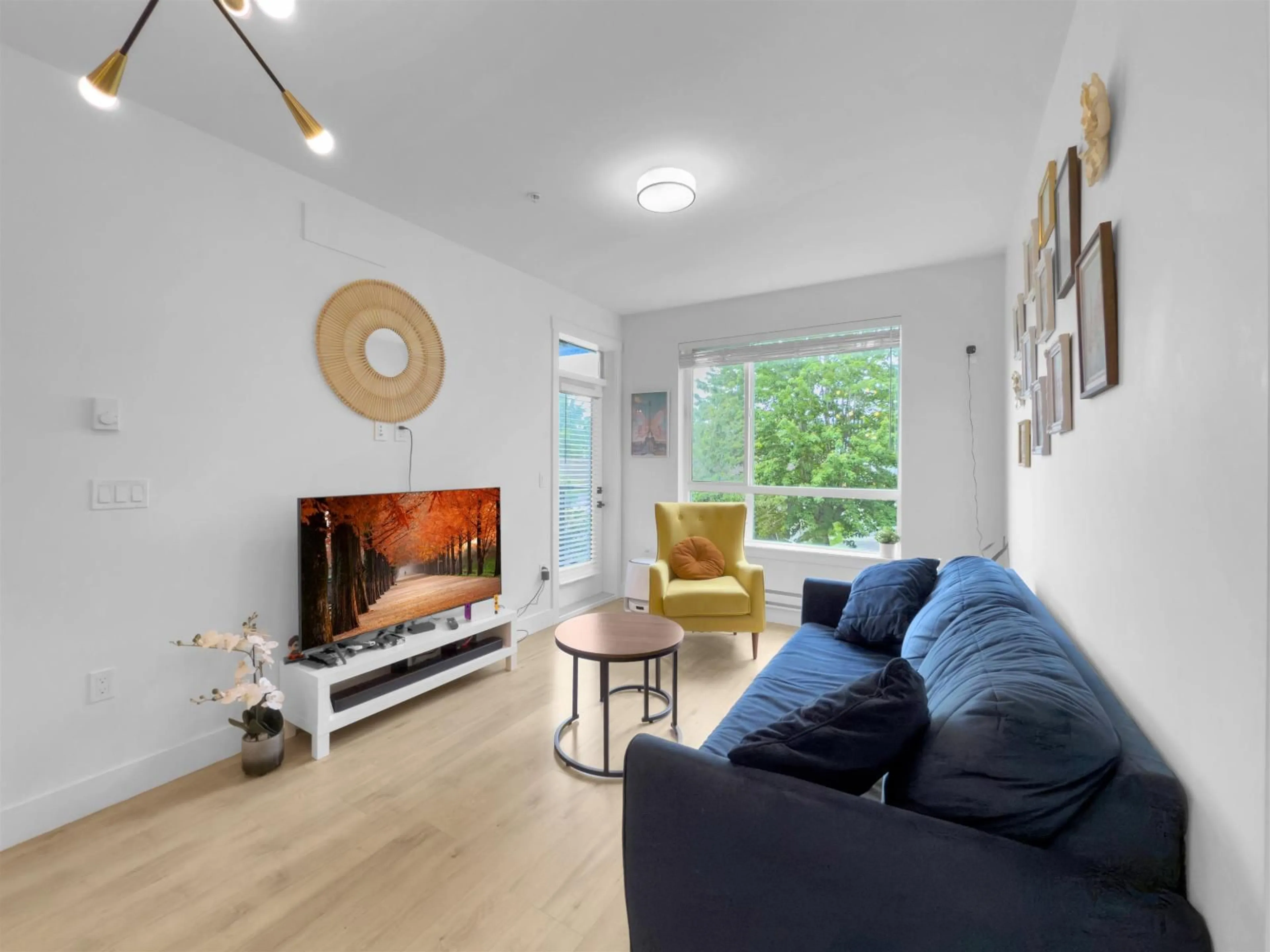 Living room with furniture, wood/laminate floor for 209 - 19935 75A, Langley British Columbia V2Y4L6