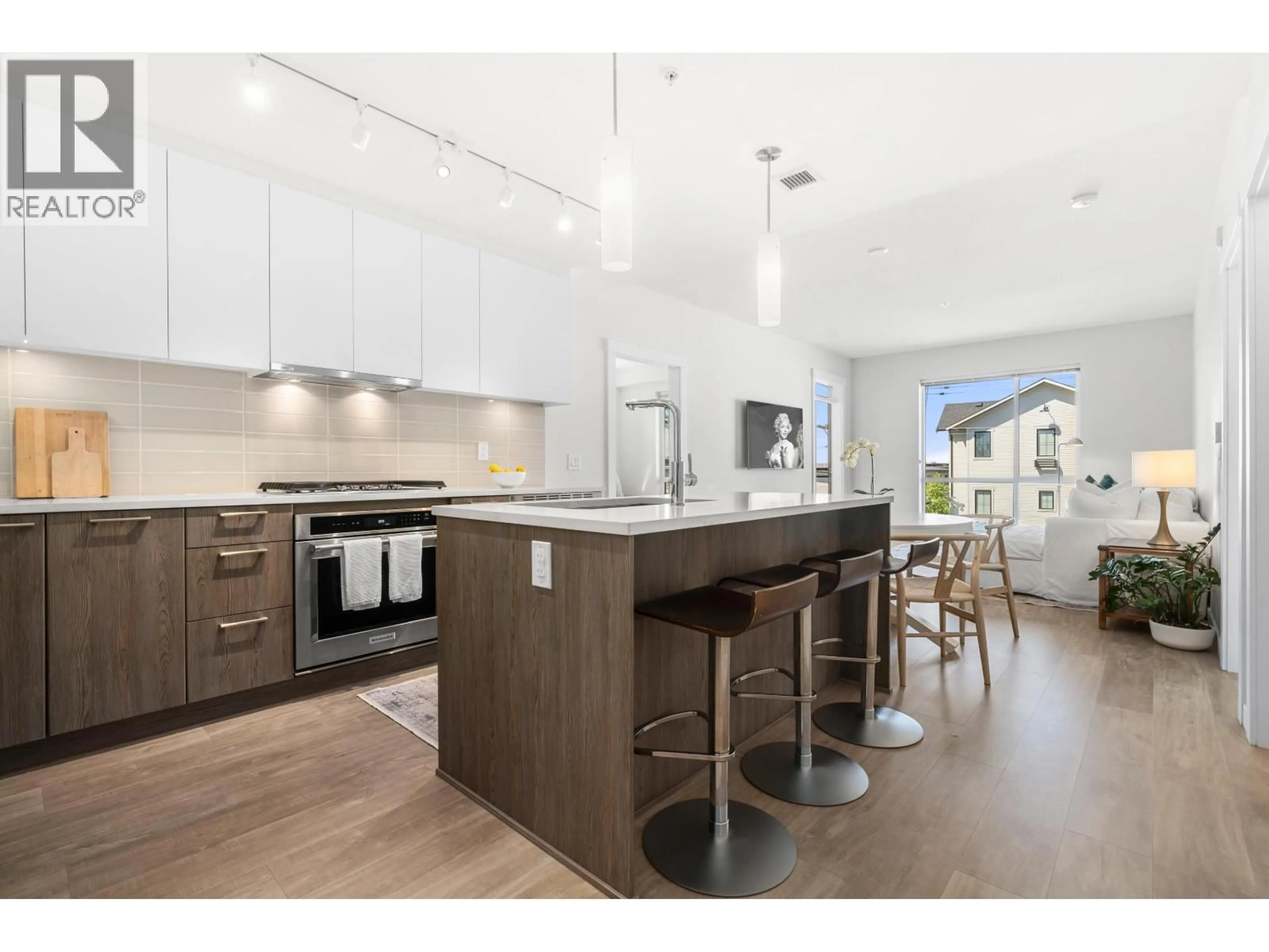 Open concept kitchen, wood/laminate floor for 205 - 615 3RD STREET, North Vancouver British Columbia V7L0G3