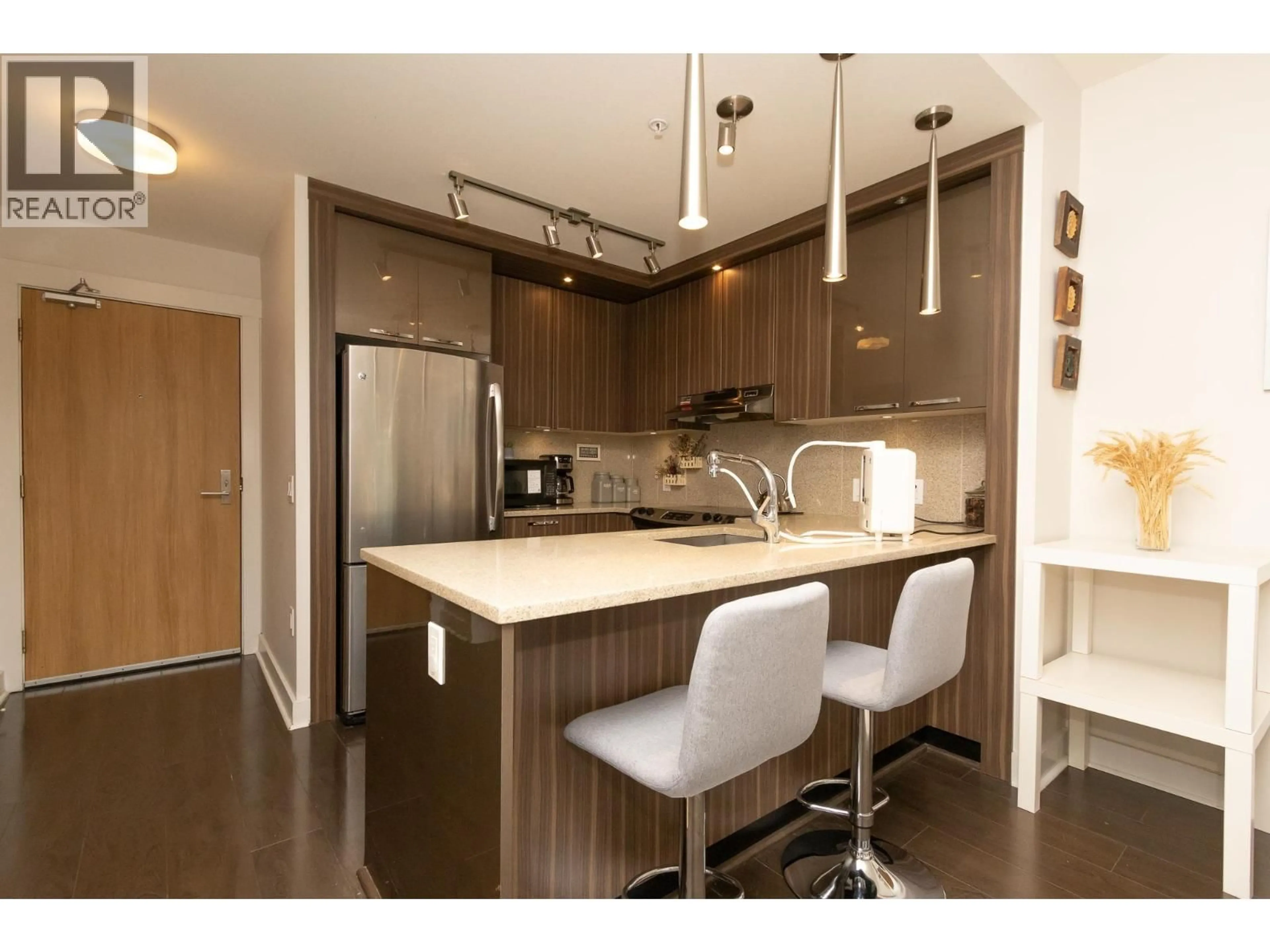 Open concept kitchen, wood/laminate floor for 310 - 733 14TH STREET, North Vancouver British Columbia V7M0C6