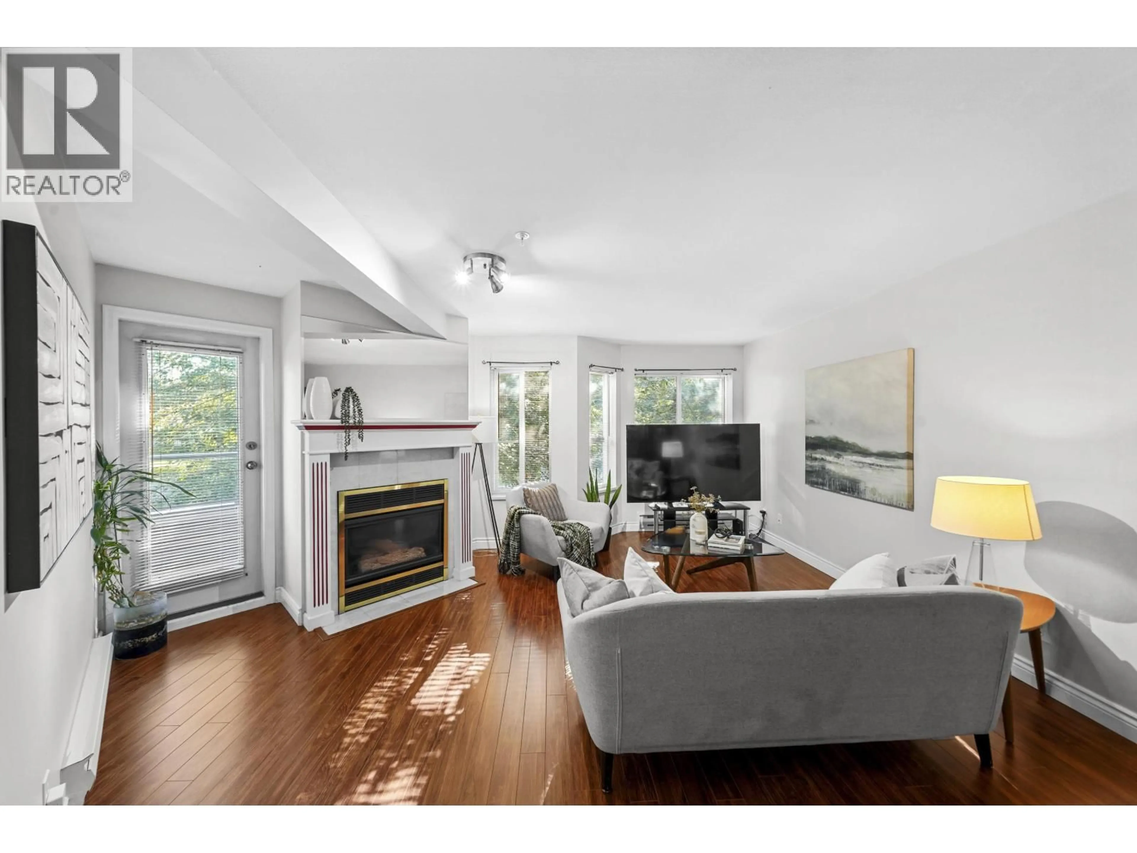 Living room with furniture, wood/laminate floor for 206 - 2620 JANE STREET, Port Coquitlam British Columbia V3C6J3