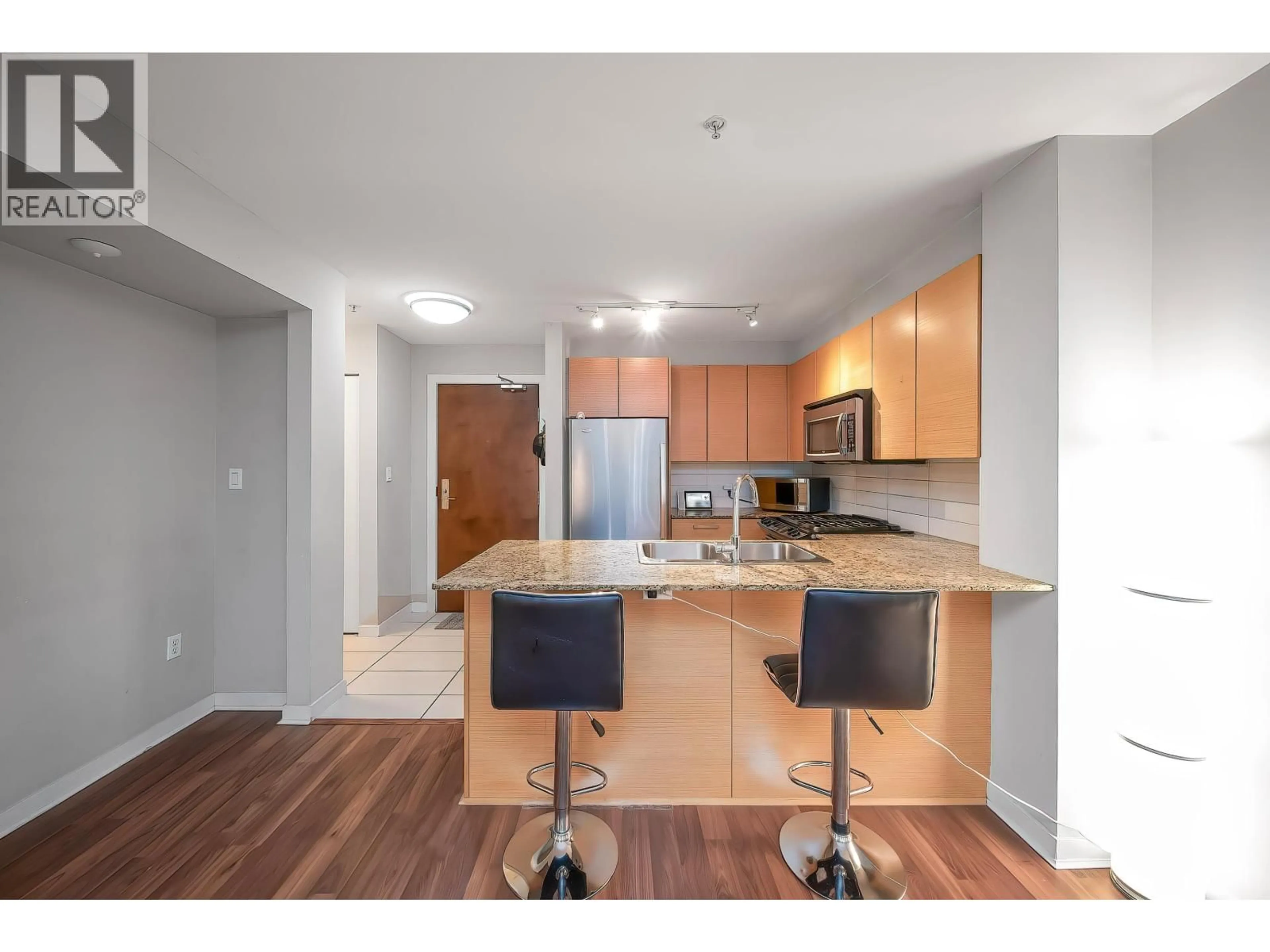 Open concept kitchen, wood/laminate floor for 106 - 5665 IRMIN STREET, Burnaby British Columbia V5J0C4
