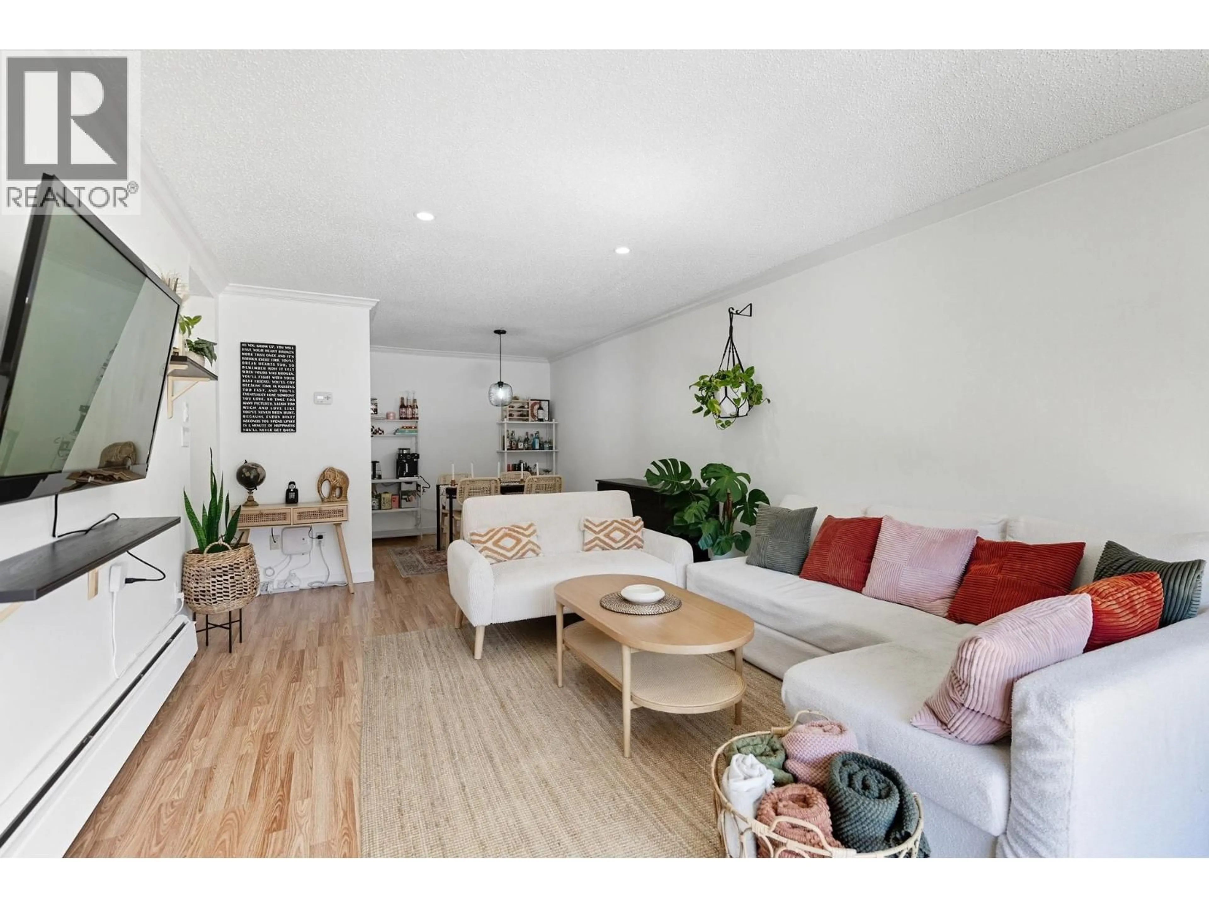 Living room with furniture, wood/laminate floor for 102 - 8820 NO. 1 ROAD, Richmond British Columbia V7C4C1
